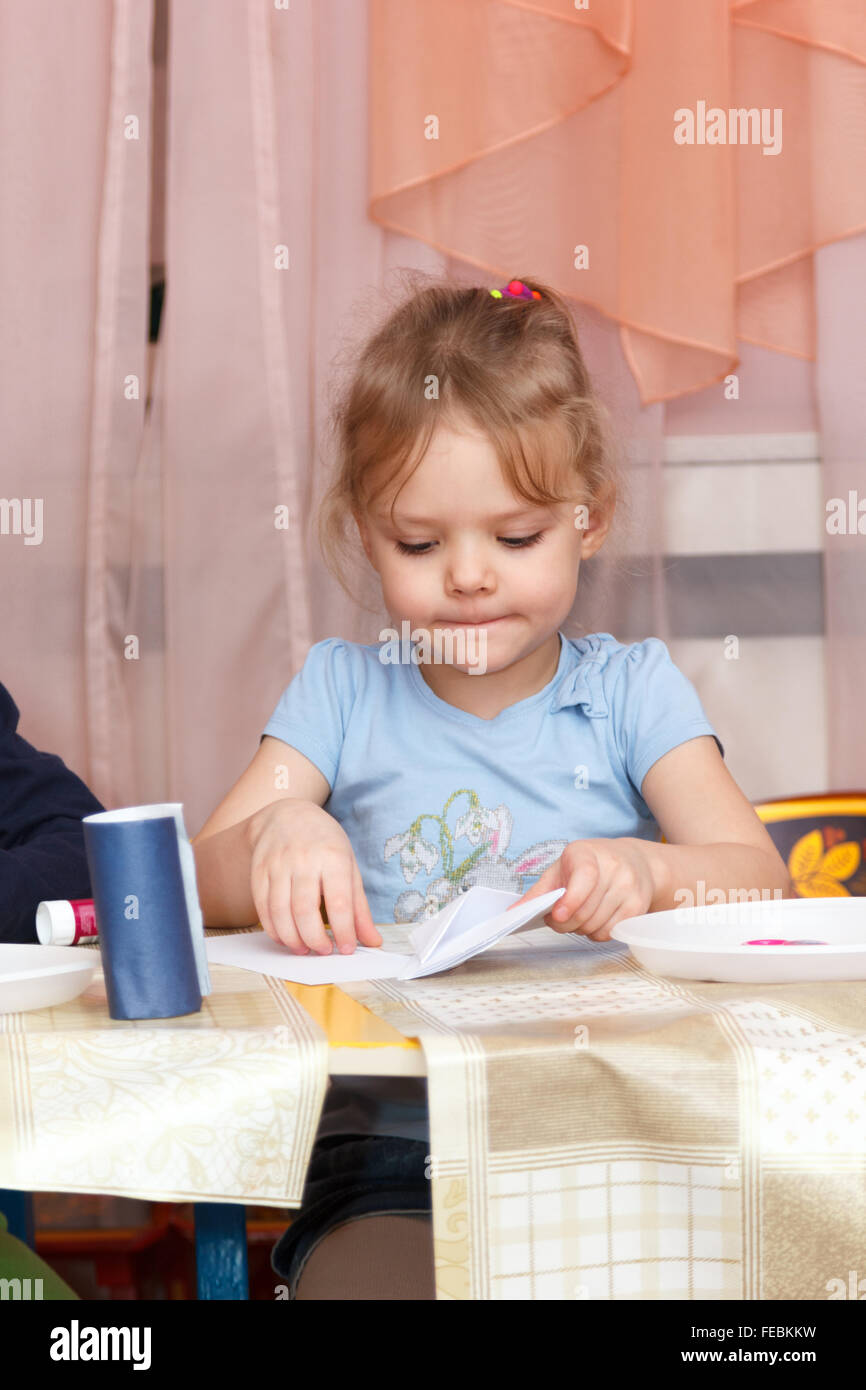 little girl sitting at a school desk Stock Photo Alamy
