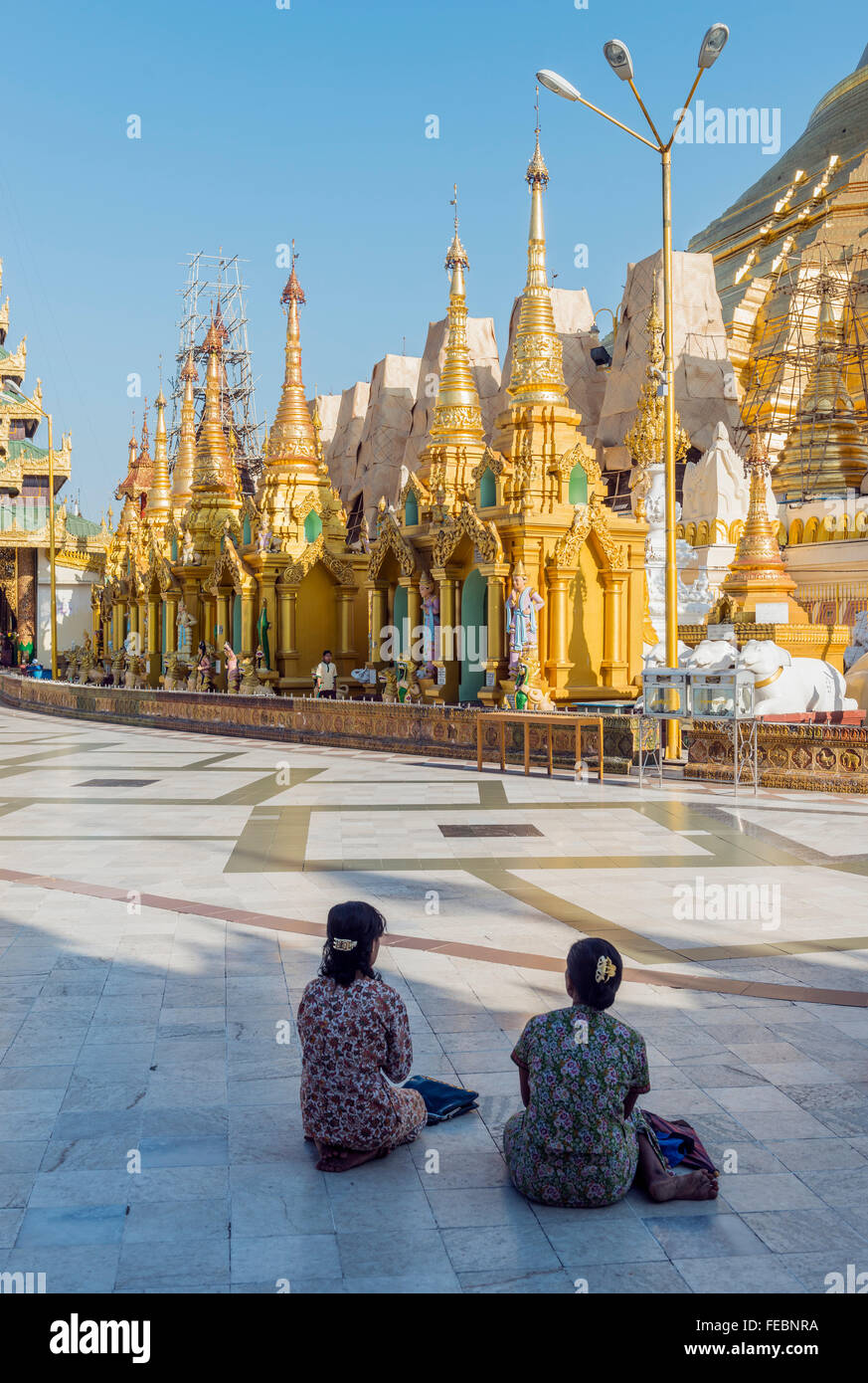 Women praying at the Shwedagon pagoda. Rangoon, Burma Stock Photo