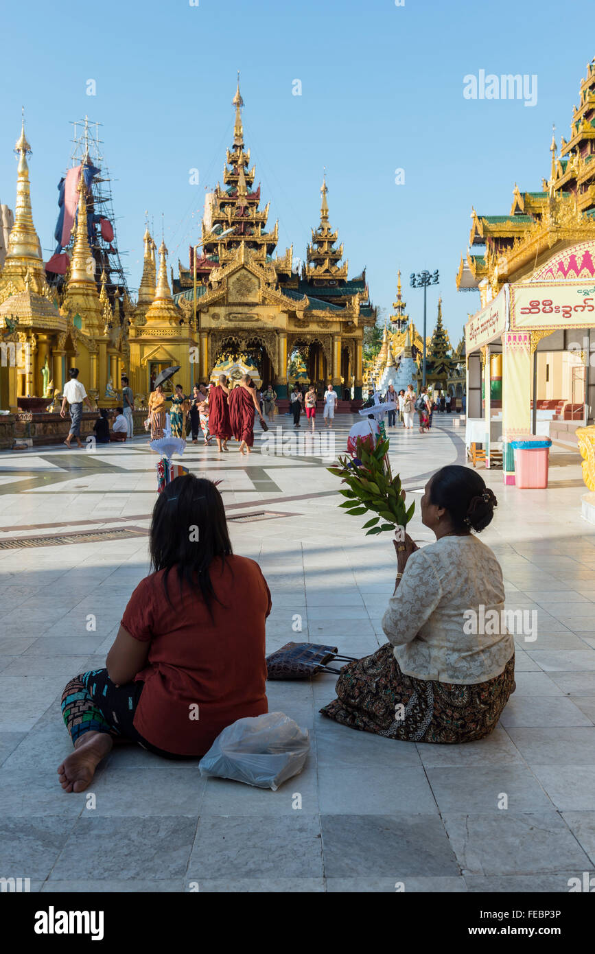 Women praying at the Shwedagon pagoda. Rangoon, Burma Stock Photo