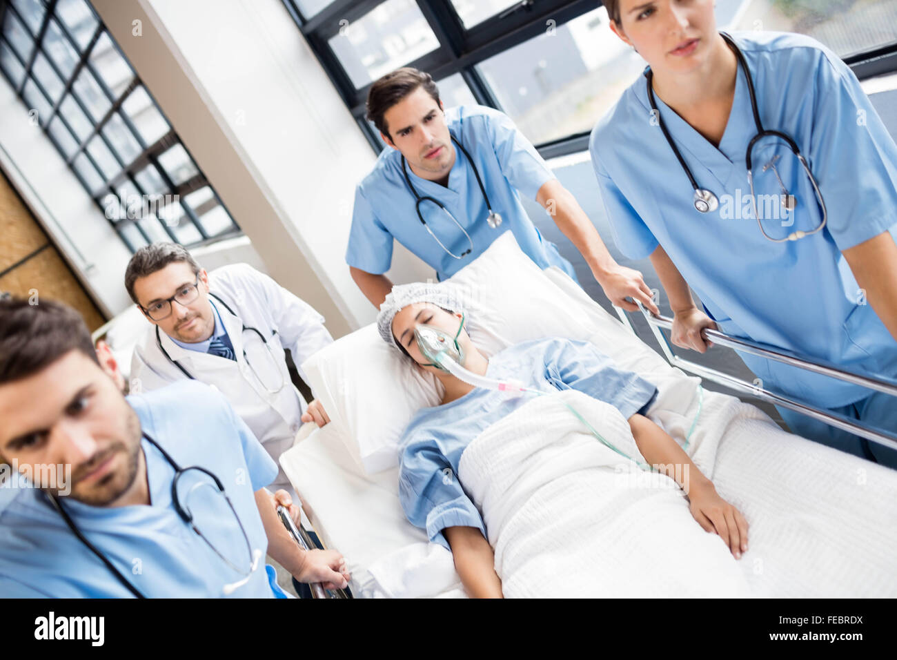Medical team pushing patient on trolley Stock Photo Alamy