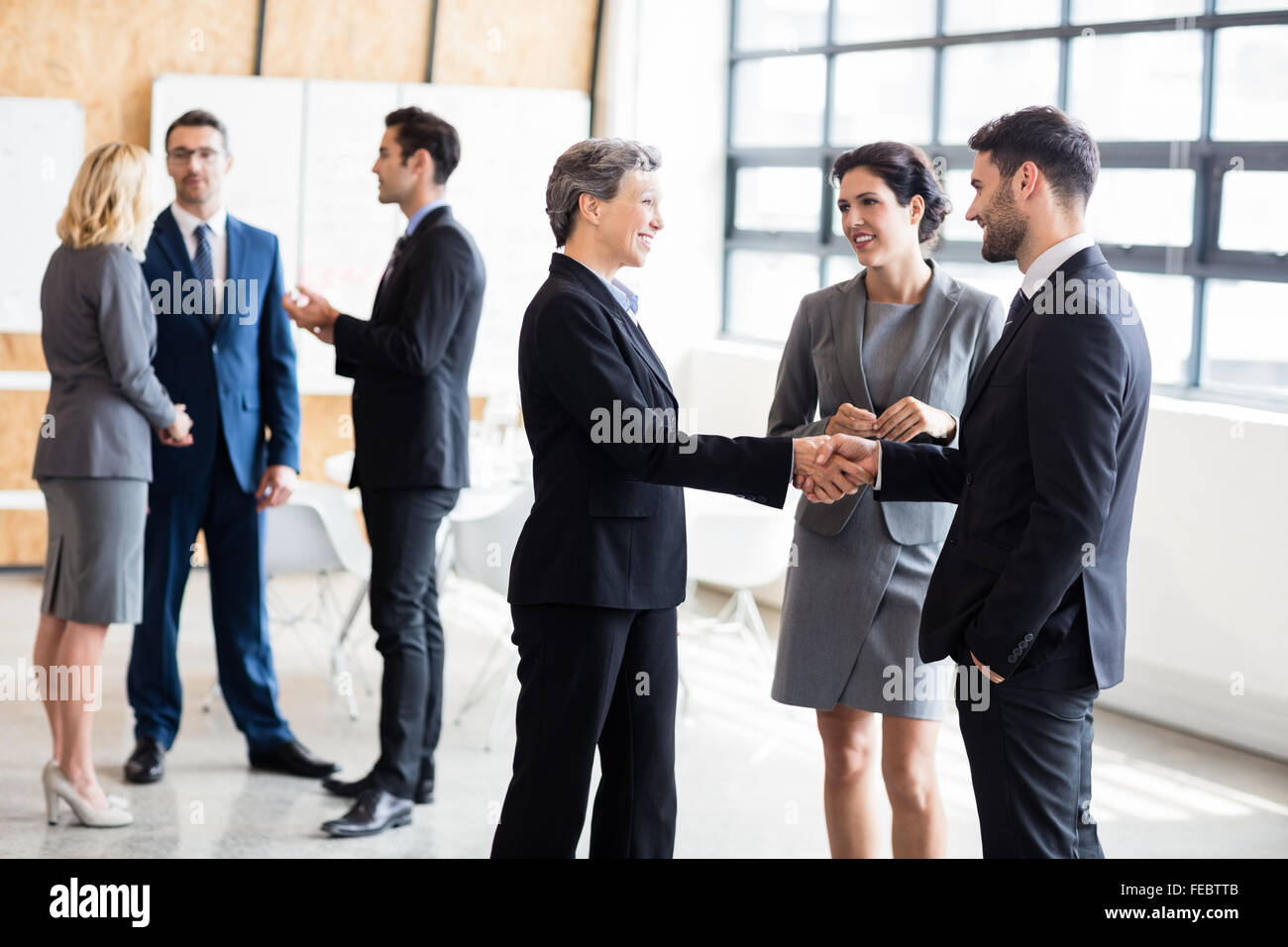 Business people standing and talking Stock Photo - Alamy