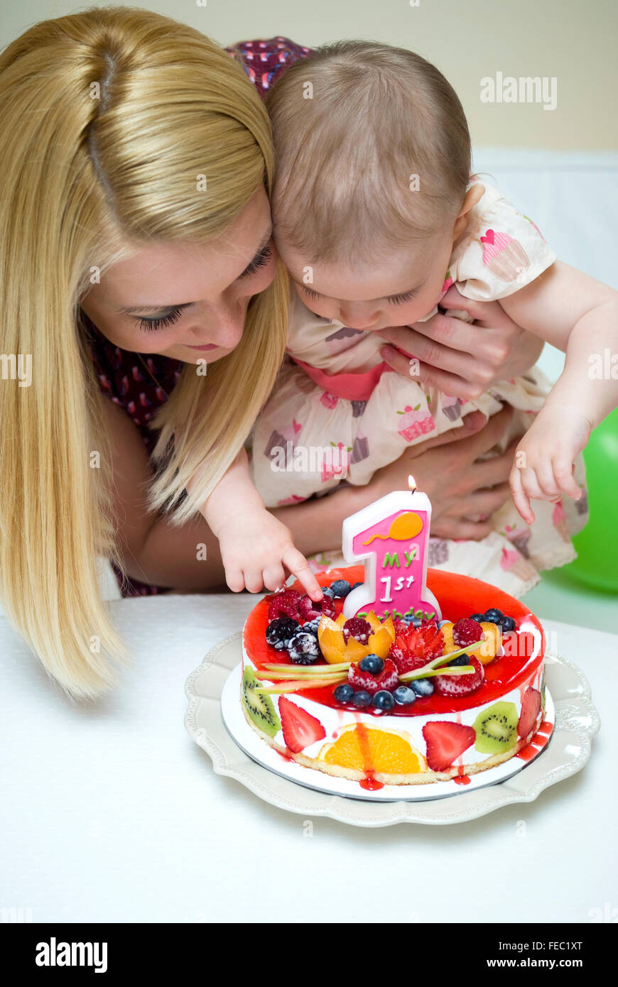 Mother and baby with birthday cake Stock Photo