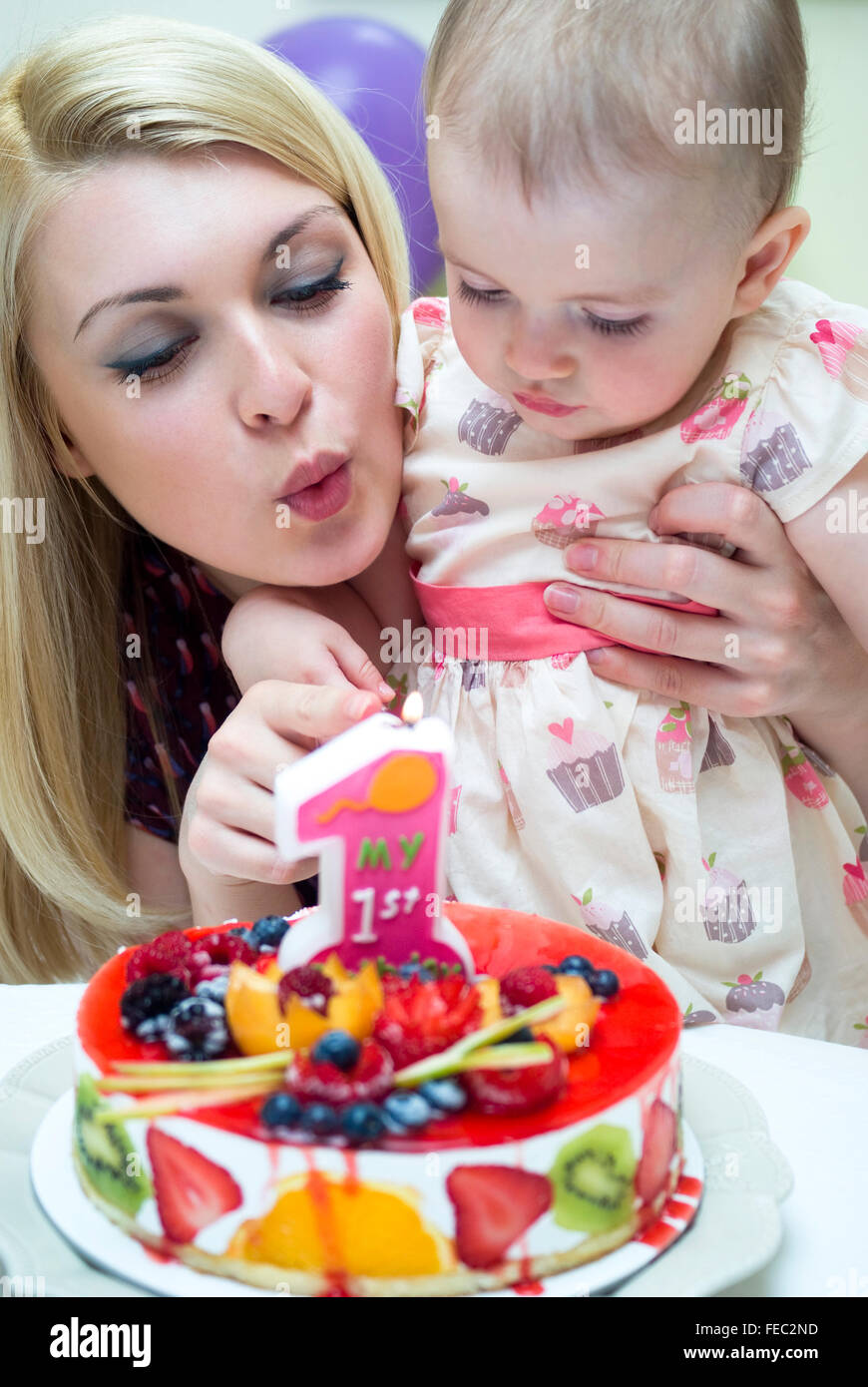 Mother celebrating baby's first birthday Stock Photo