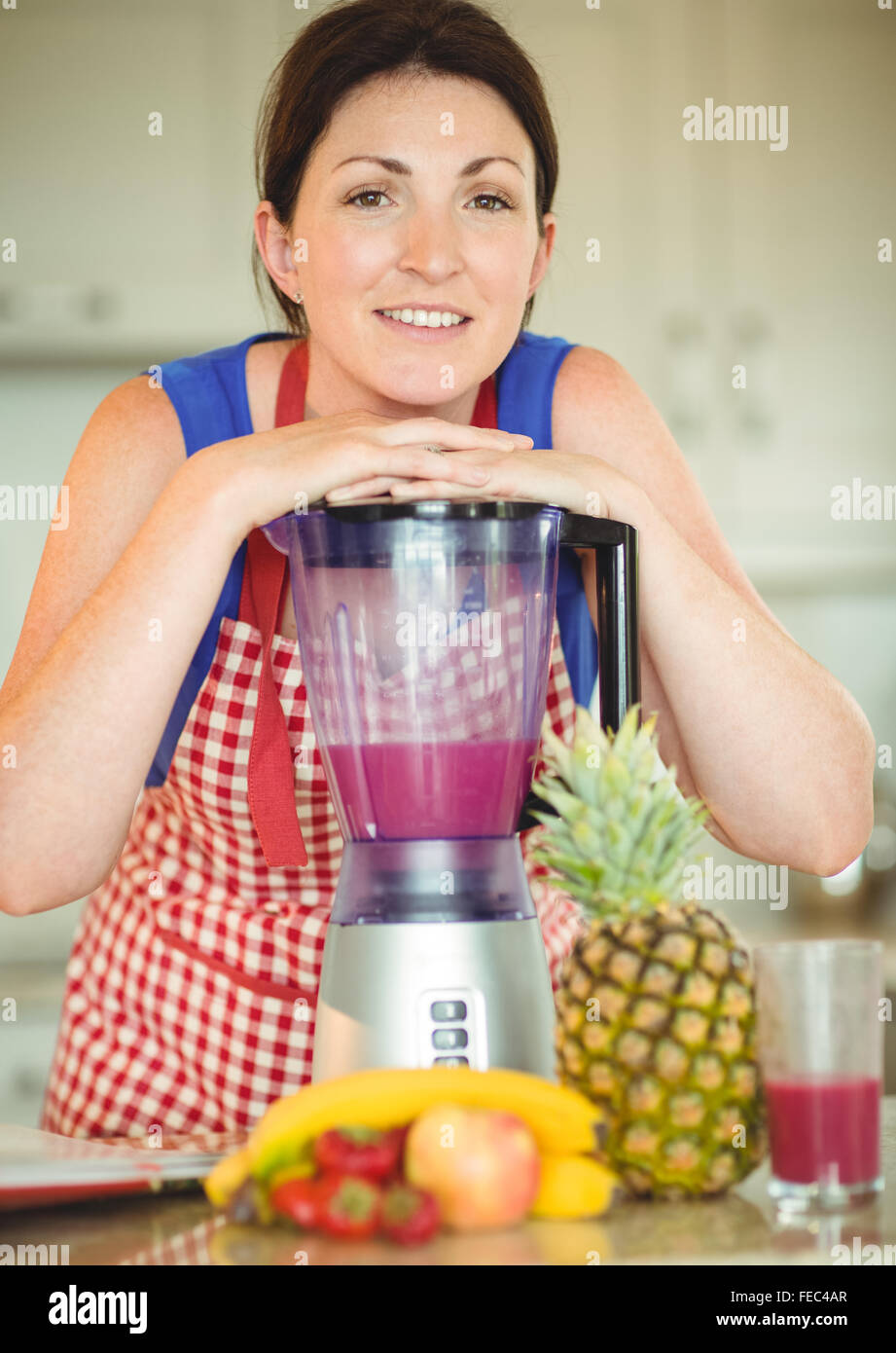 Woman leaning face on mixer Stock Photo - Alamy