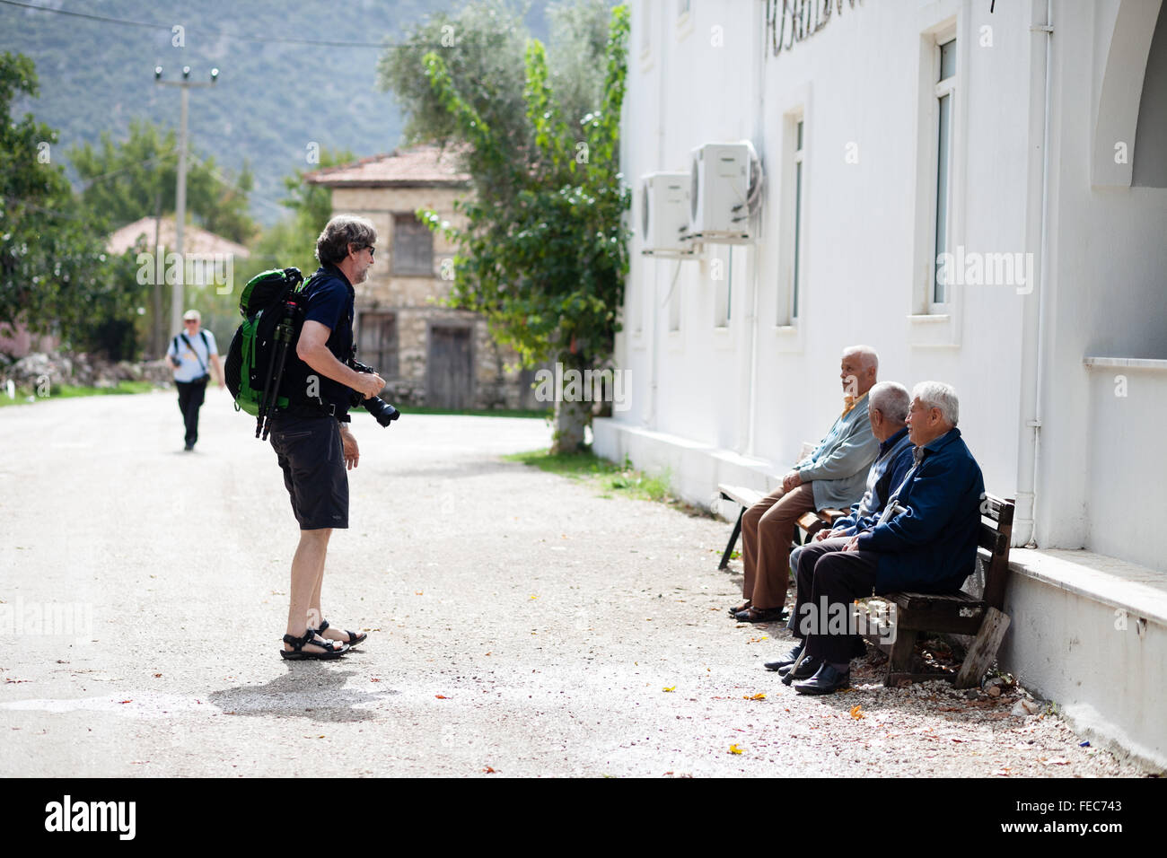Portrait practice - a tourist takes photos of locals in Bezigan a rural village near Kalkan, Lycian Way, Turkey Stock Photo