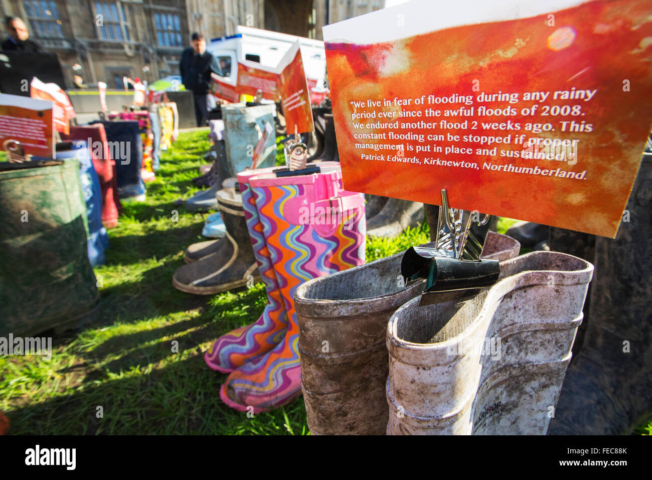 On Thursday 28th January 2016 Greenpeace UK handed in a petition to Downing Street protesting about the recent catastrophic flooding. As part of the day, an art instalation of Wellington Boots were place outside the Houses of Parliament. On each pair of boots a message was attached from someone who had been affected by the floods. Stock Photo