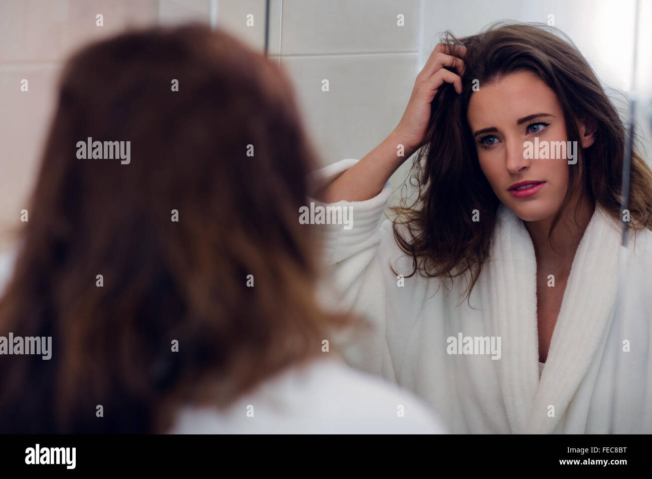 Beautiful brunette with messy hair and bathrobe Stock Photo