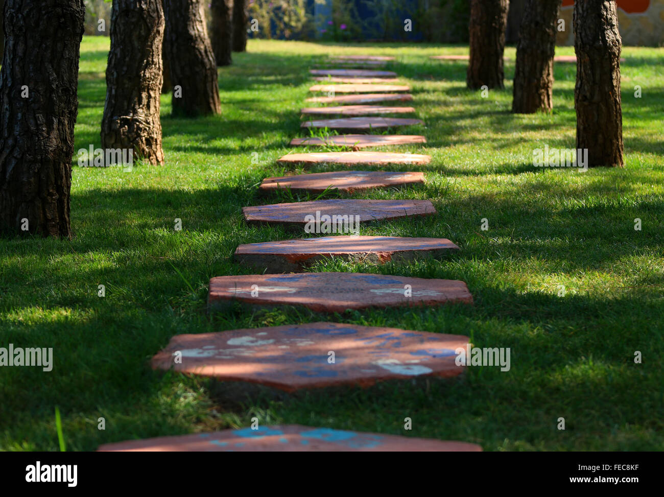 Foot path in the grass, made from concrete plates. Stock Photo