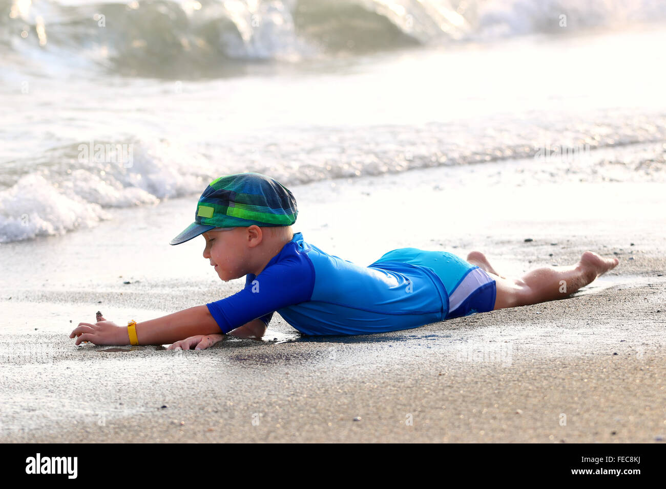 Small boy having fun on the sand beach. Stock Photo