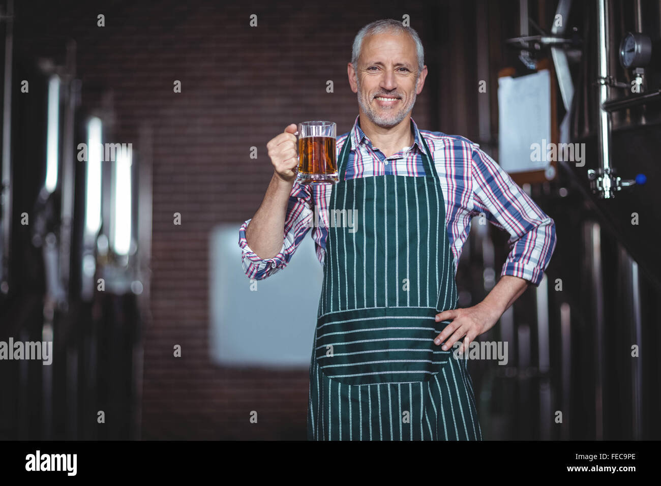Happy brewer working in the plant Stock Photo