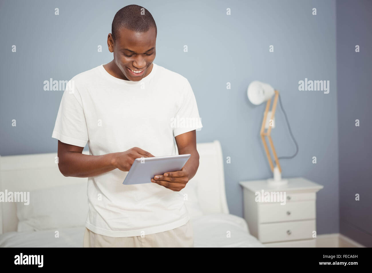 Handsome man using tablet Stock Photo - Alamy