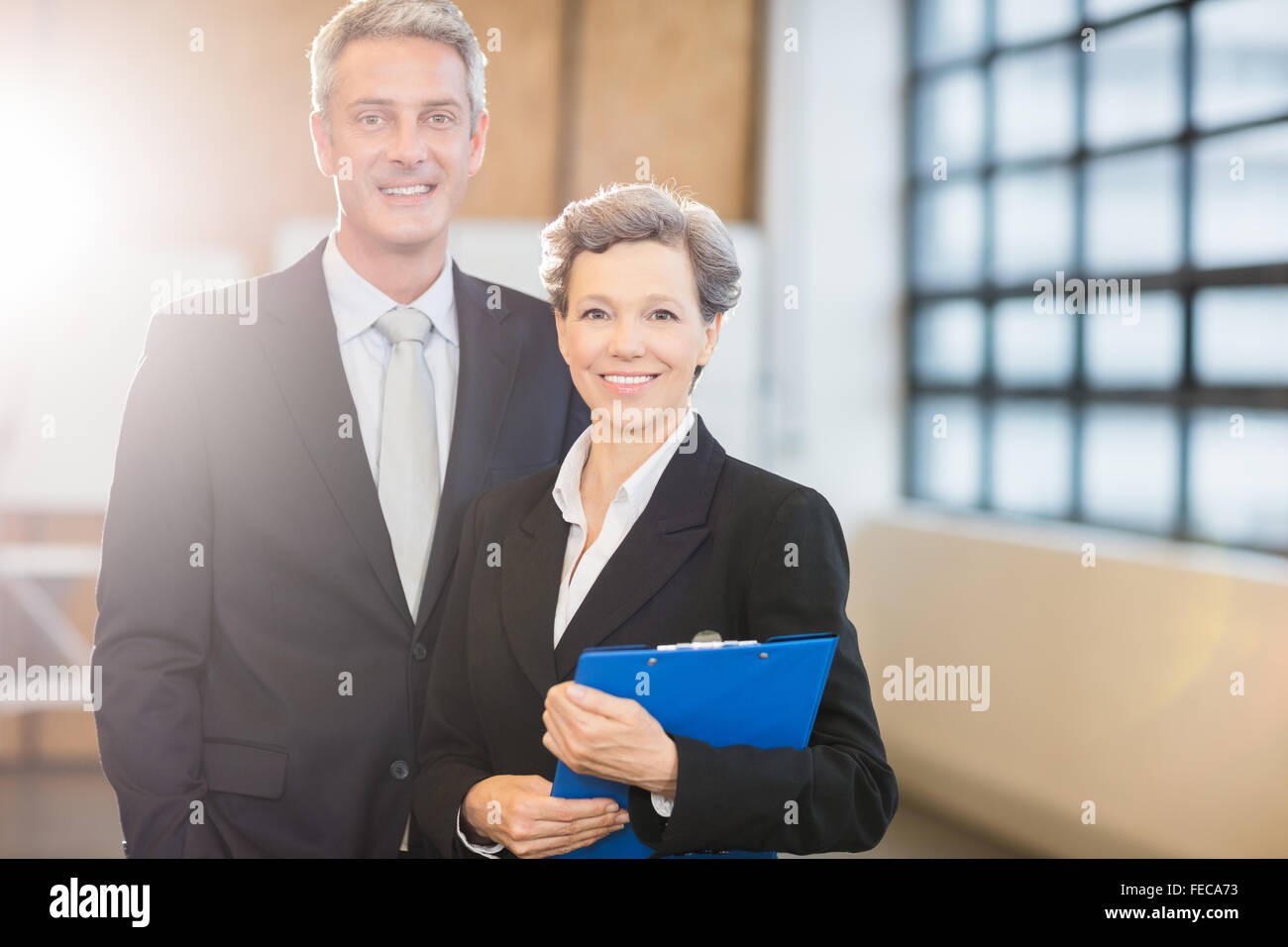 Business team smiling at camera together Stock Photo - Alamy