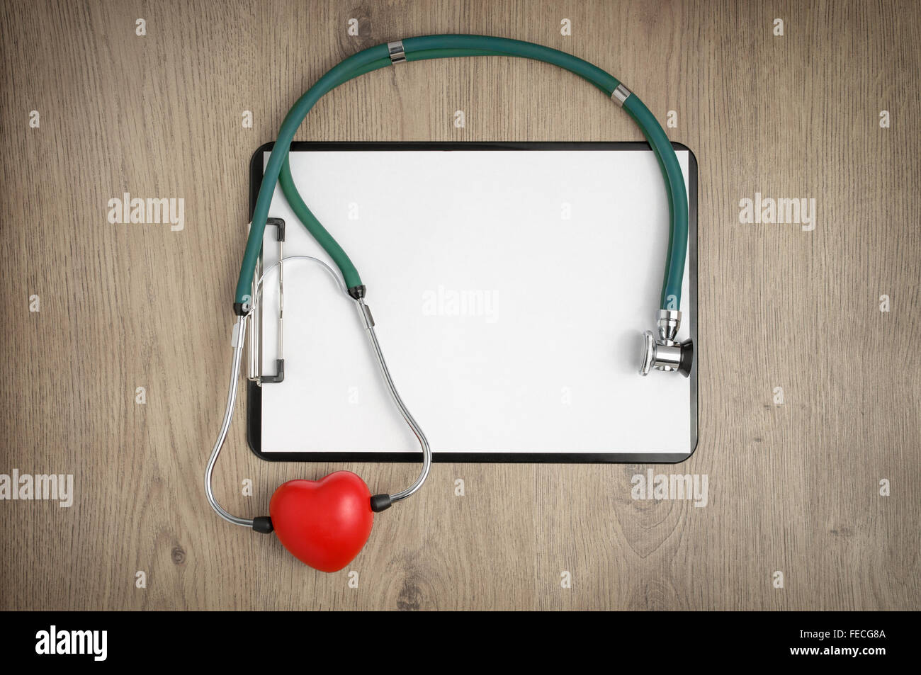 Clipboard with blank white paper, stethoscope and heart shape on wooden ...