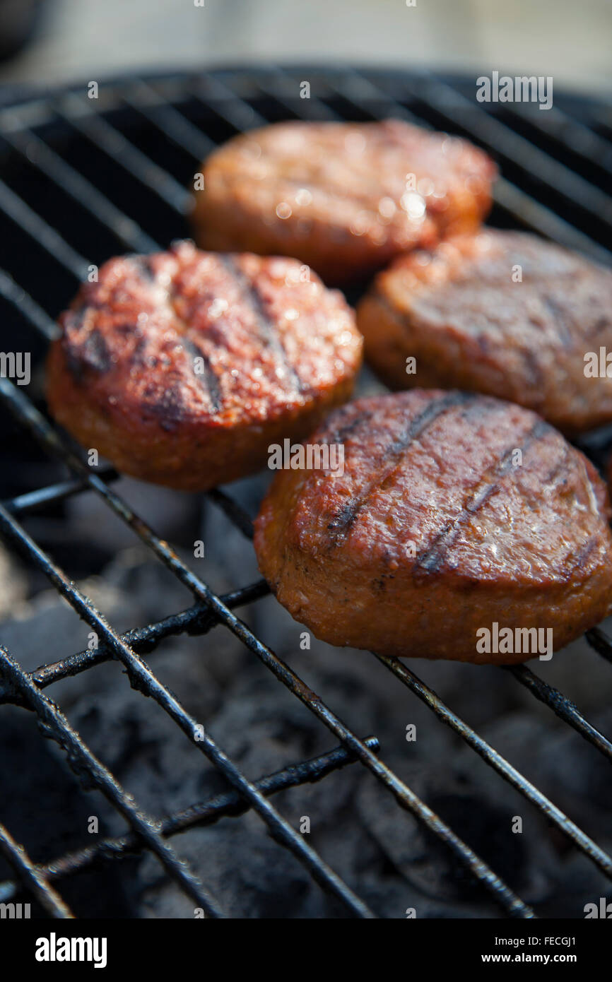 Beef Hamburgers on the grill Stock Photo