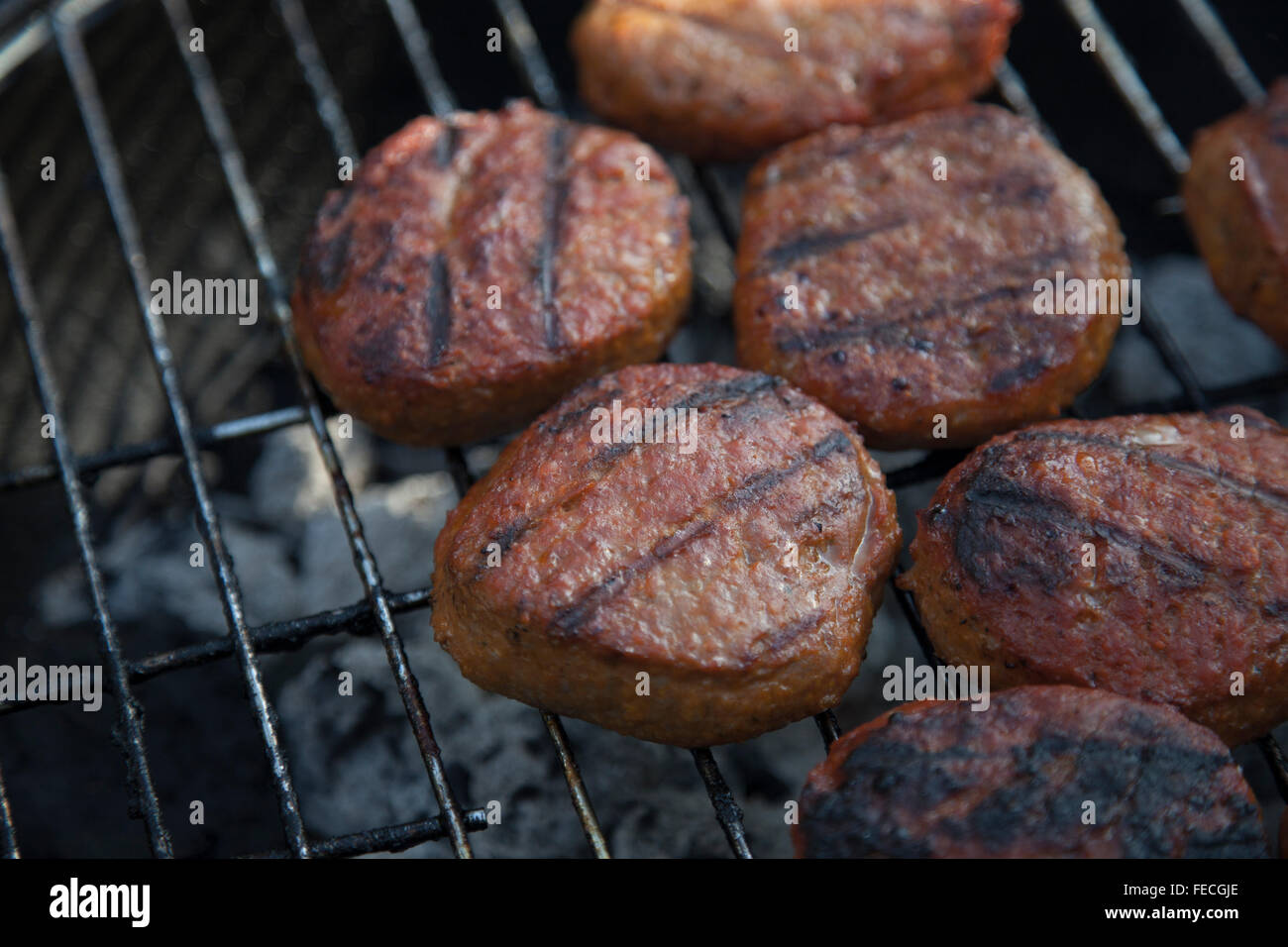 Beef Hamburgers on the grill Stock Photo