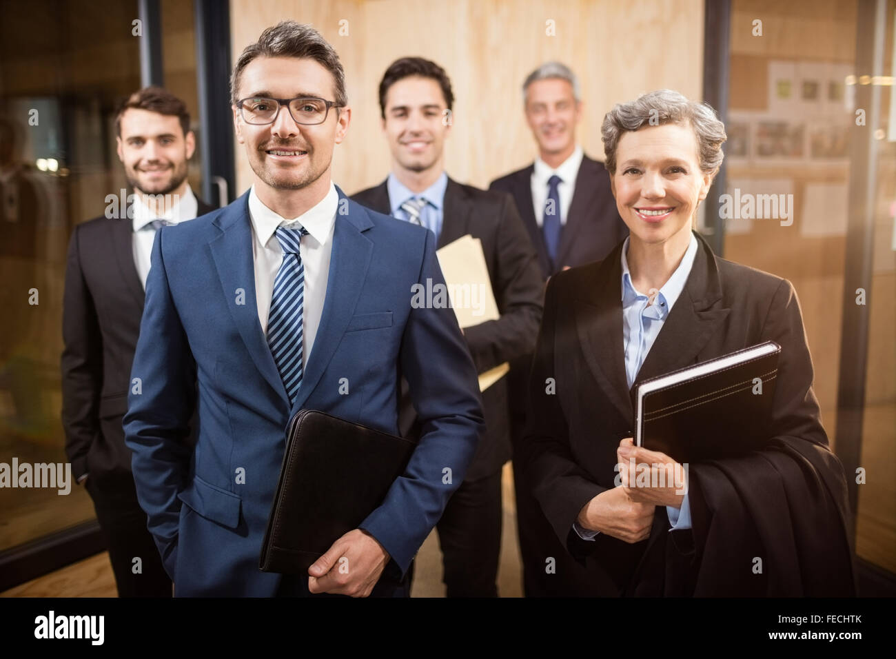 Business team smiling at the camera Stock Photo - Alamy