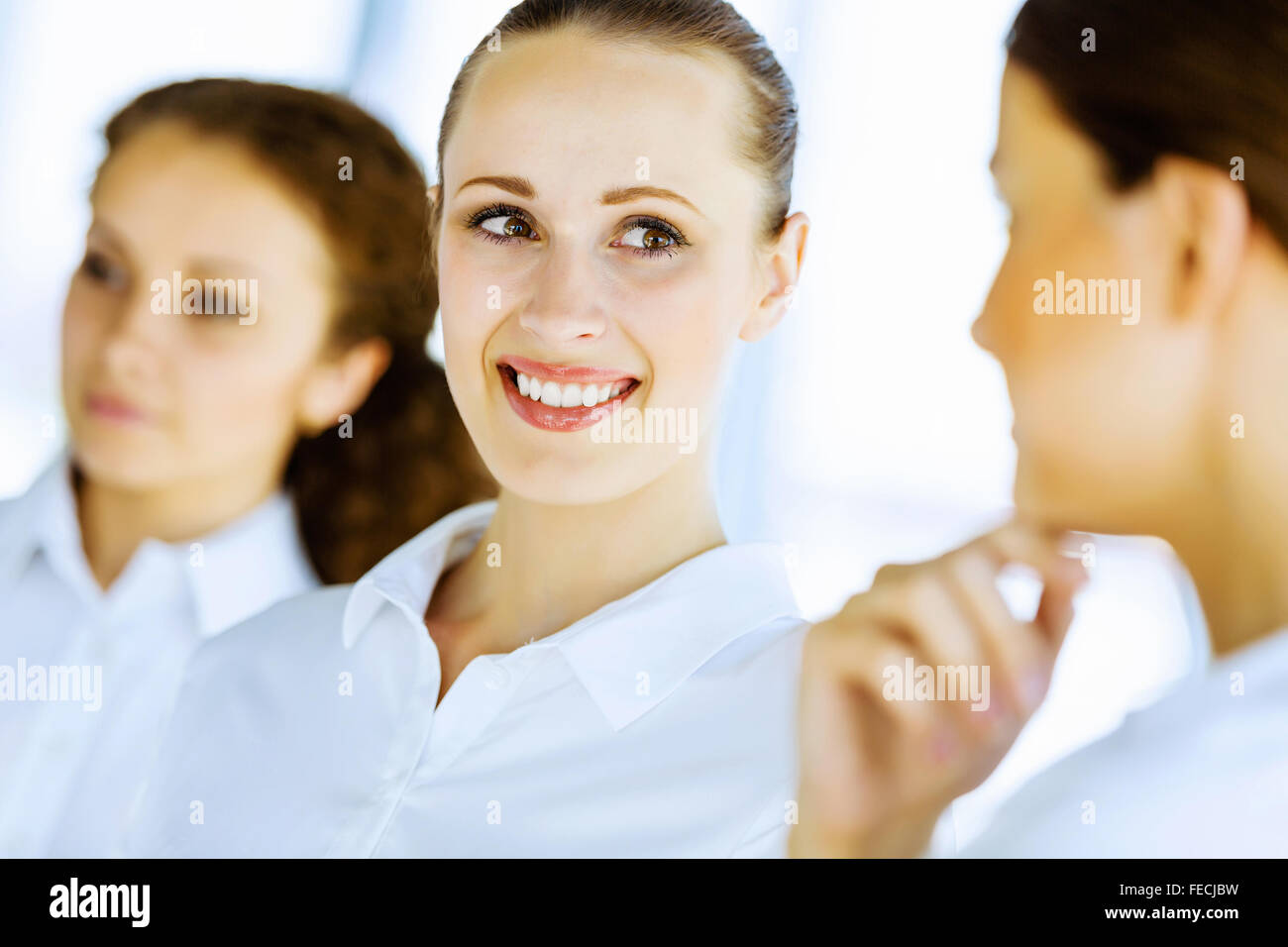 Image of three young businesswomen at meeting Stock Photo - Alamy
