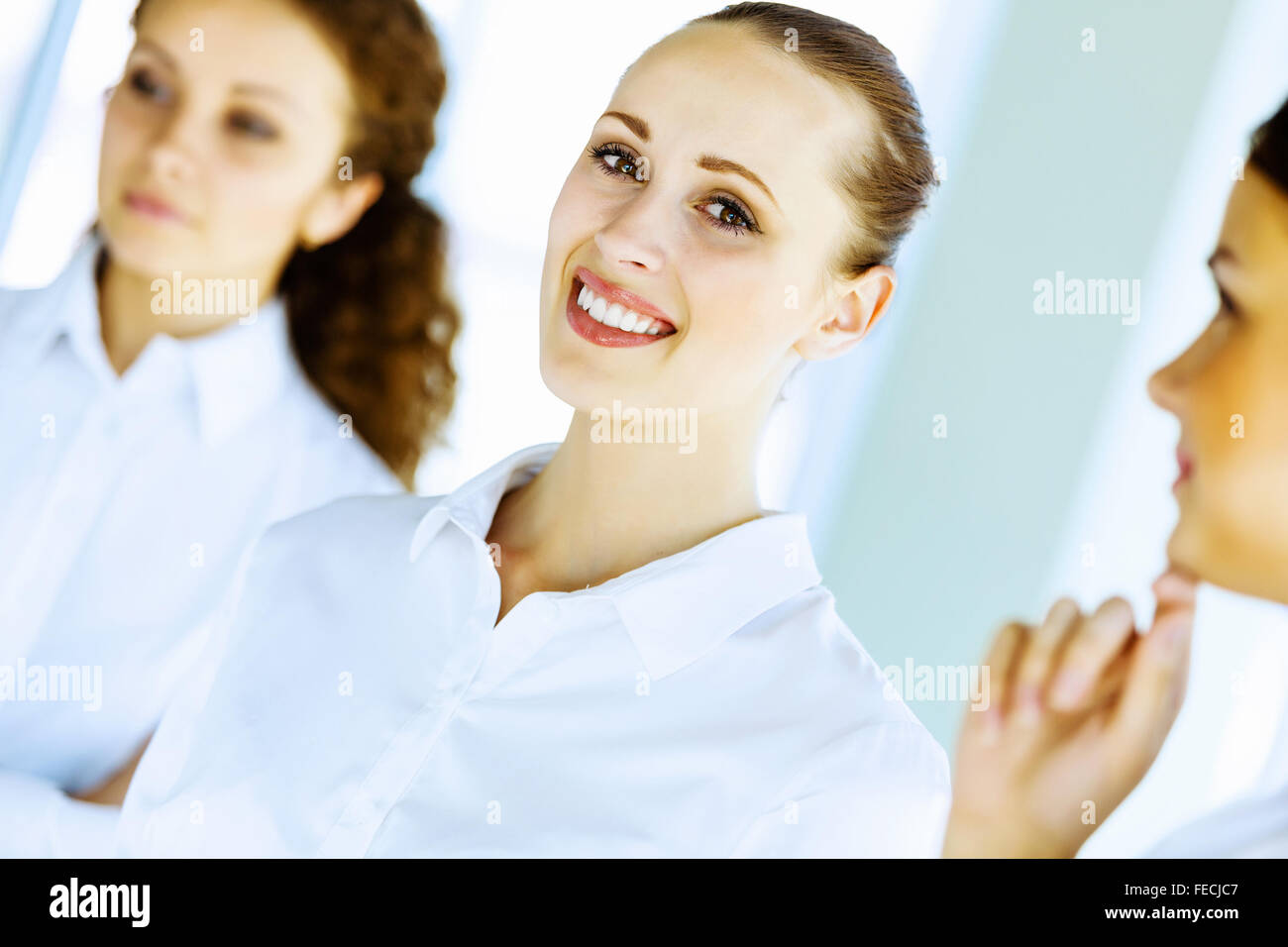 Image of three young businesswomen at meeting Stock Photo - Alamy