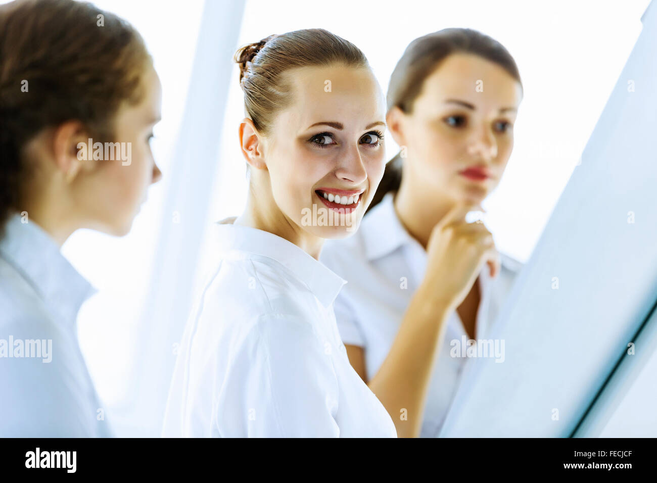 Image of three young businesswomen at meeting Stock Photo - Alamy