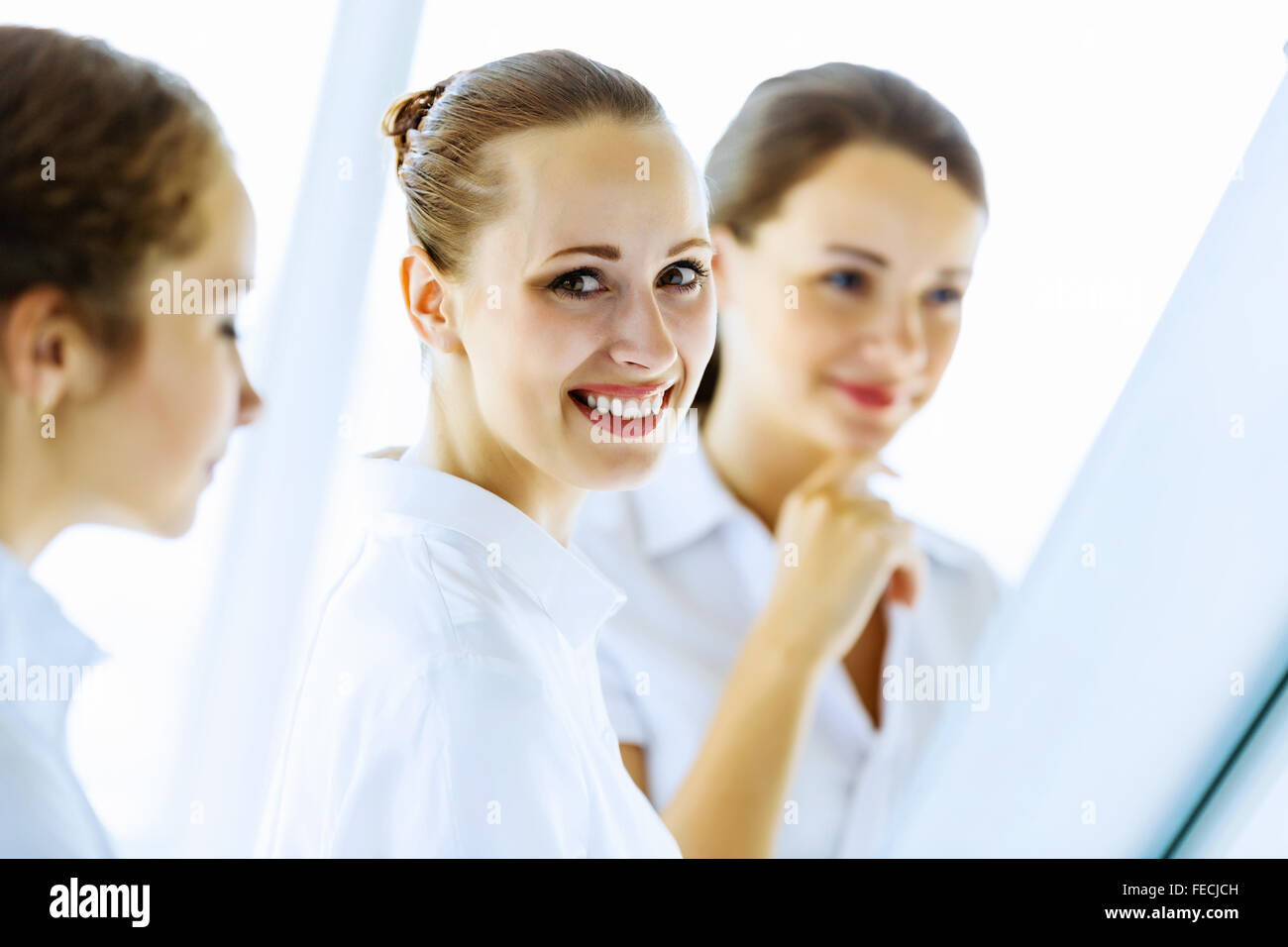 Image of three young businesswomen at meeting Stock Photo - Alamy