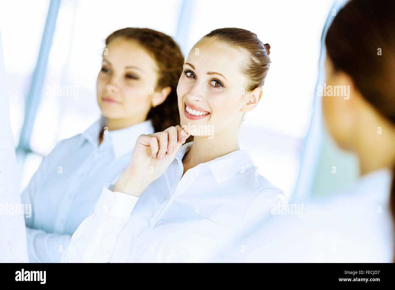 Image of three young businesswomen at meeting Stock Photo - Alamy