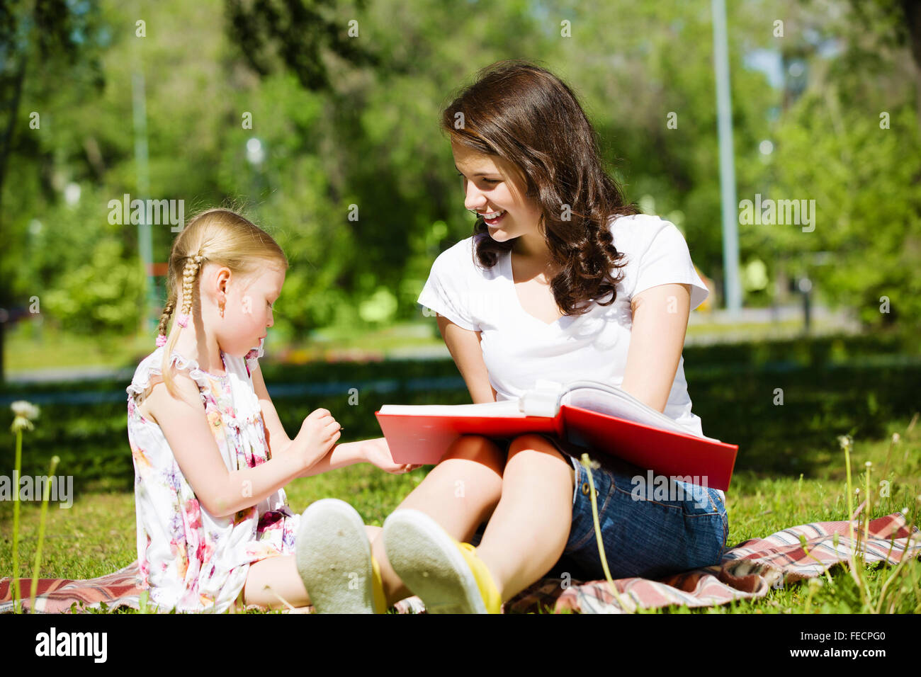 Image of cute girl and her mother playing in park Stock Photo - Alamy