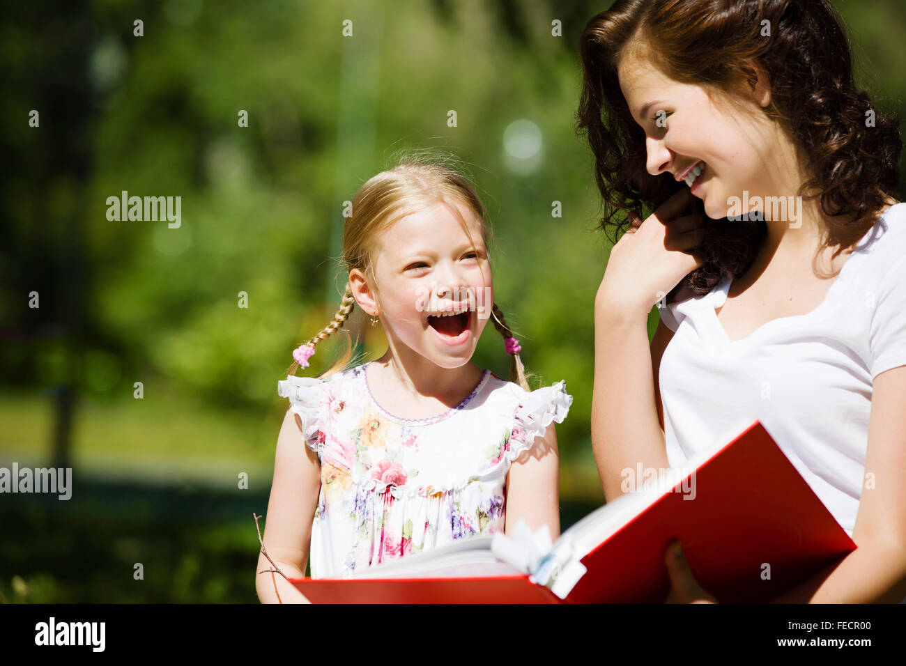 Image of cute girl and her mother playing in park Stock Photo - Alamy