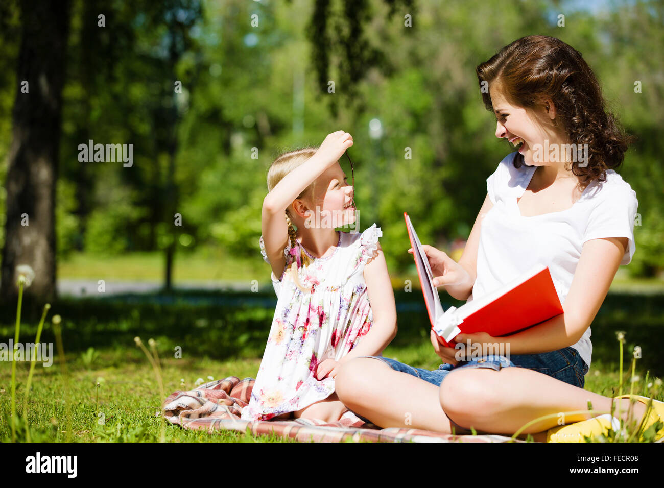 Image of cute girl and her mother playing in park Stock Photo - Alamy