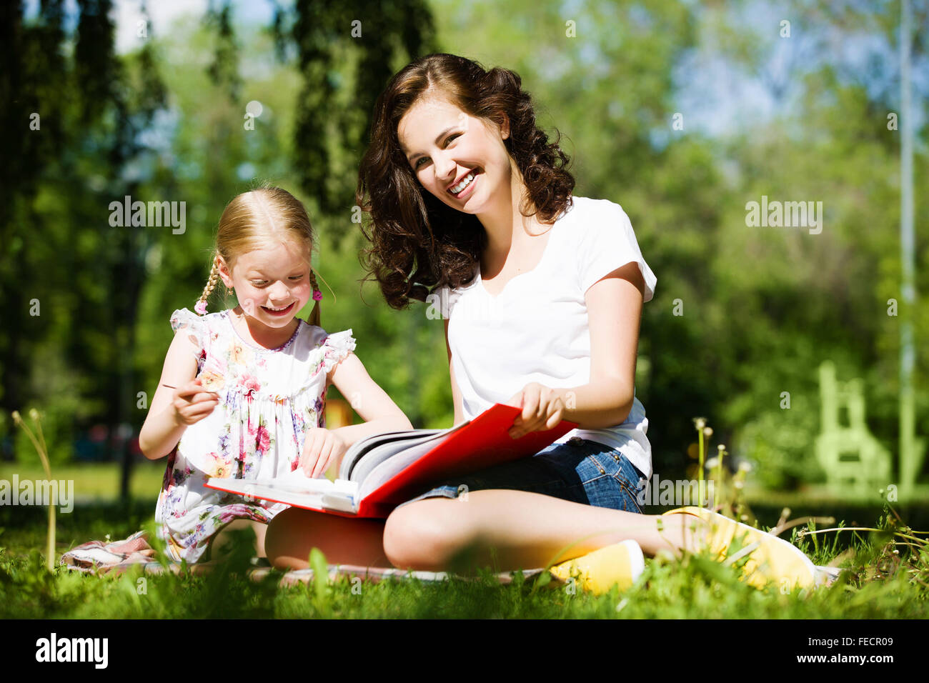 Image of cute girl and her mother playing in park Stock Photo - Alamy