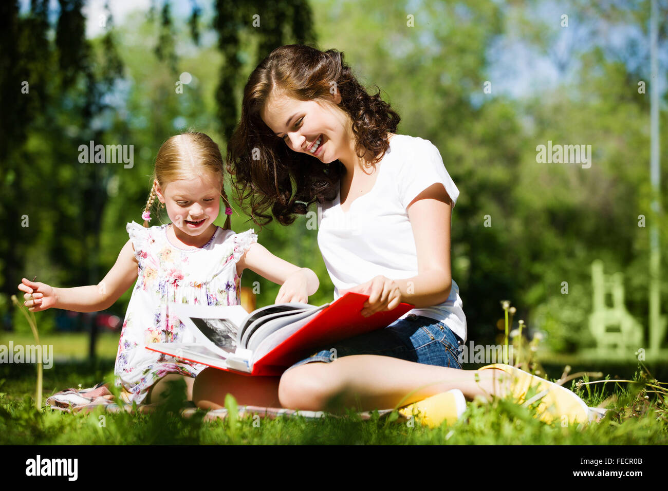 Image of cute girl and her mother playing in park Stock Photo - Alamy