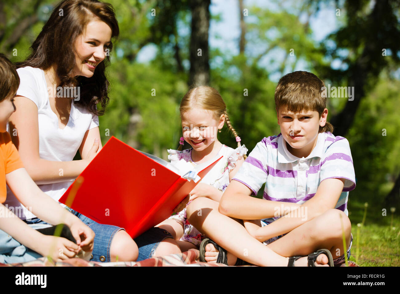 Image of children with nurse playing in park Stock Photo - Alamy