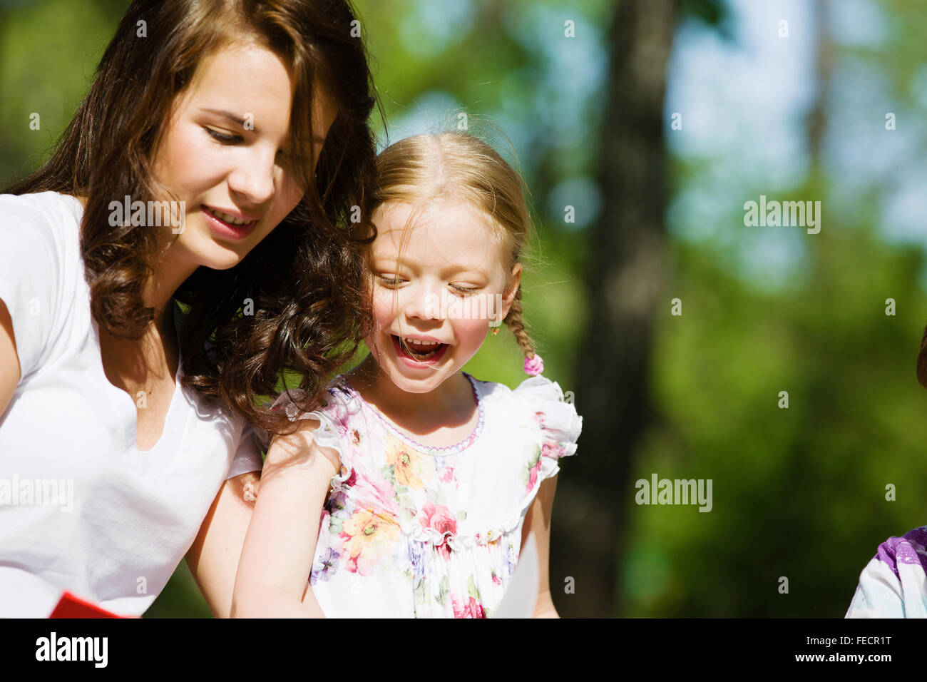 Image of cute girl and her mother playing in park Stock Photo - Alamy