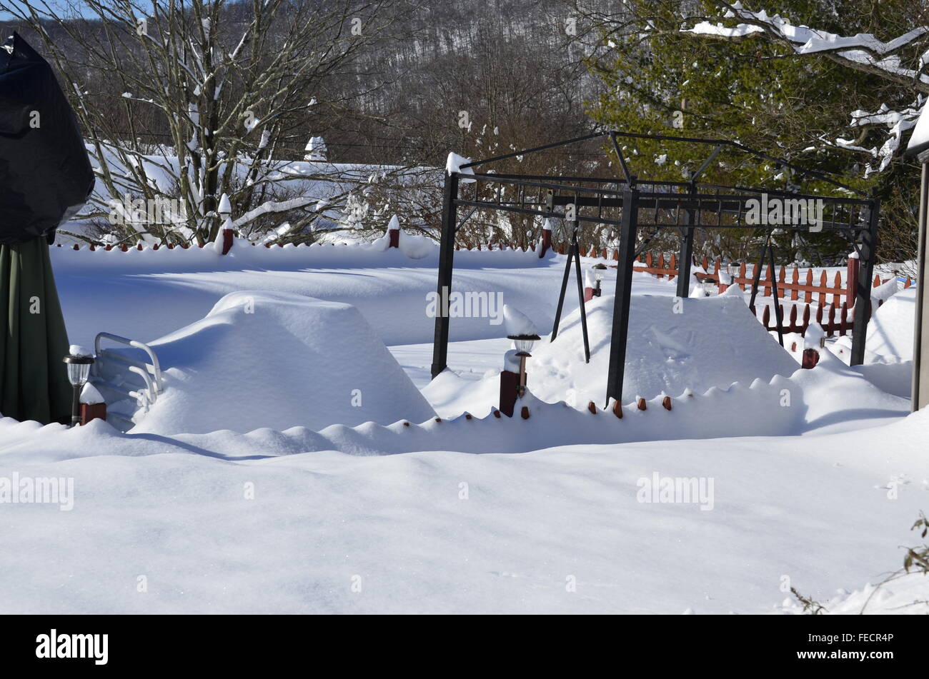 a very deep snow covering a swimming pool scene Stock Photo