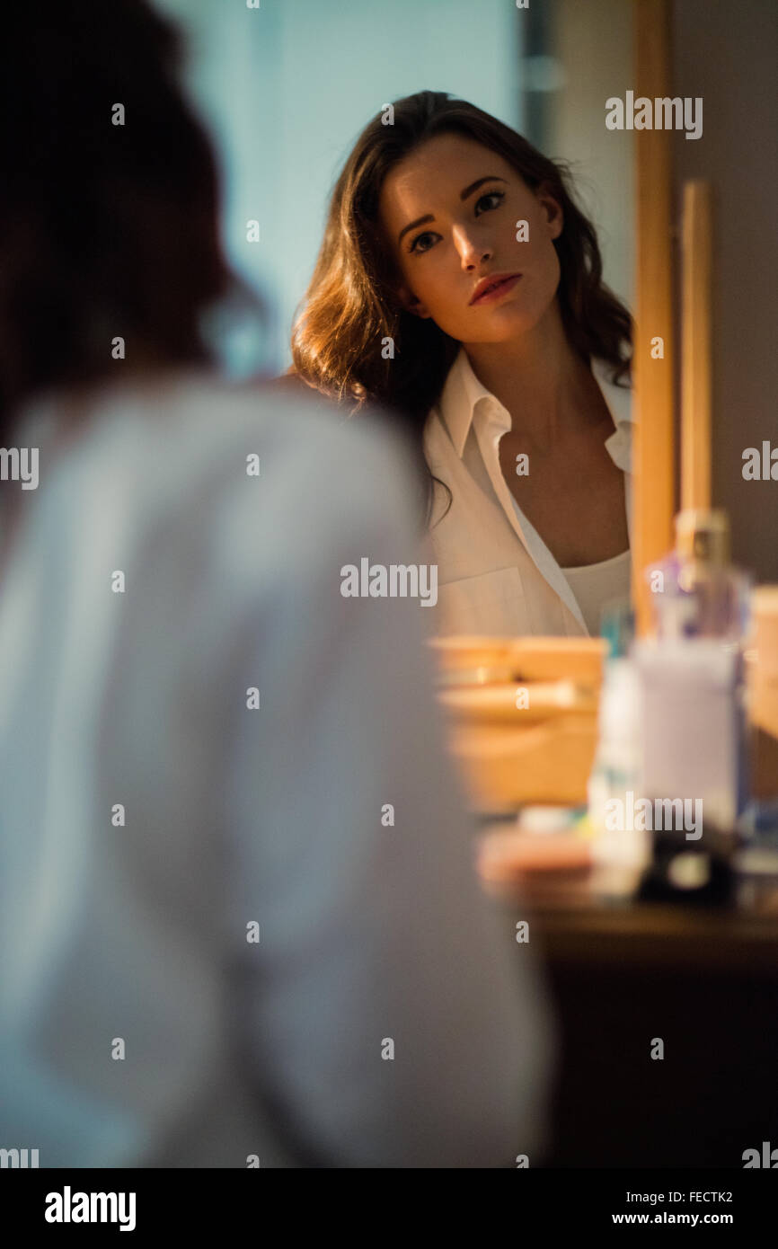 Beautiful brunette posing in front of the mirror Stock Photo - Alamy
