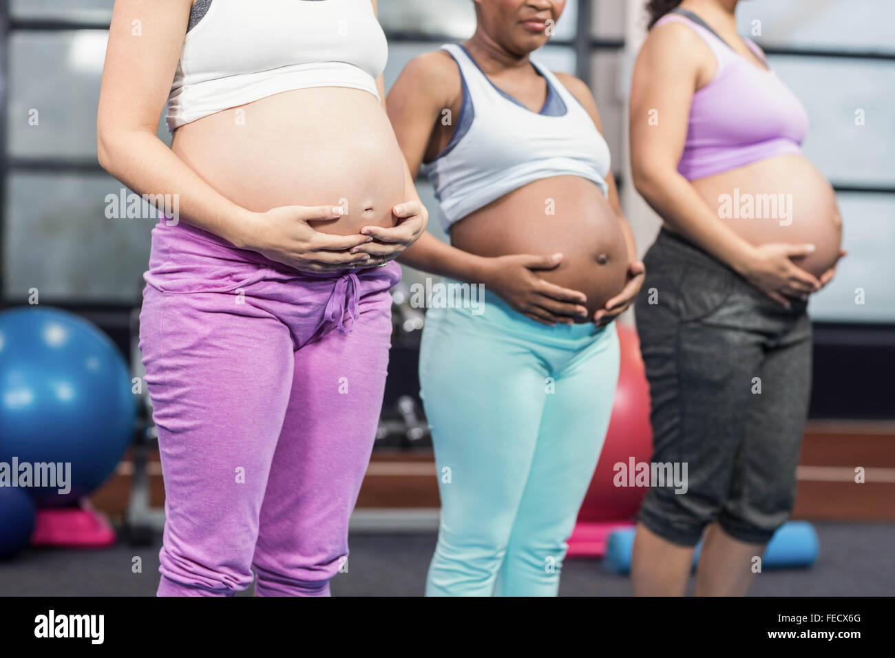 Pregnant women standing and touching bellies Stock Photo Alamy