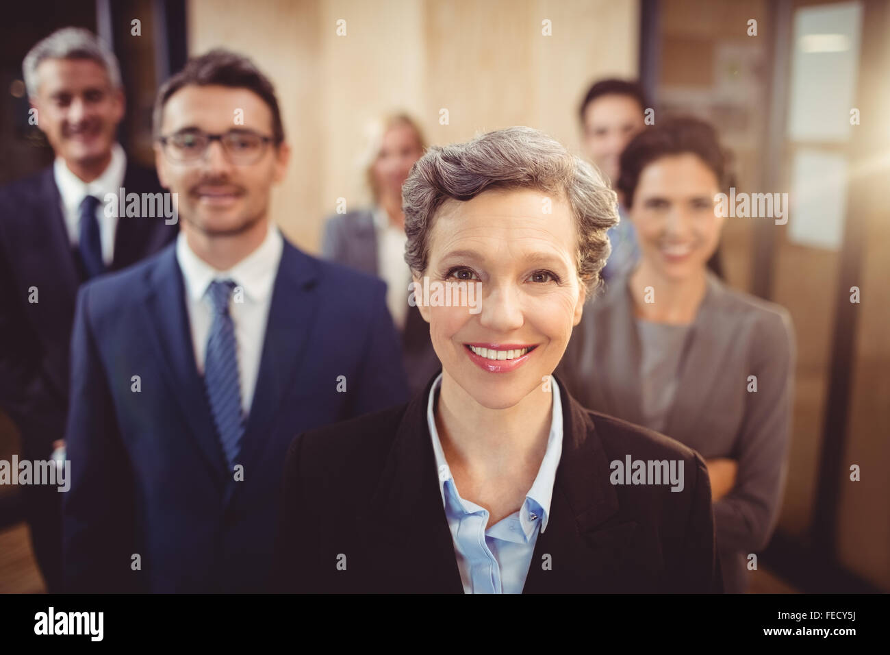Business team smiling at the camera Stock Photo - Alamy