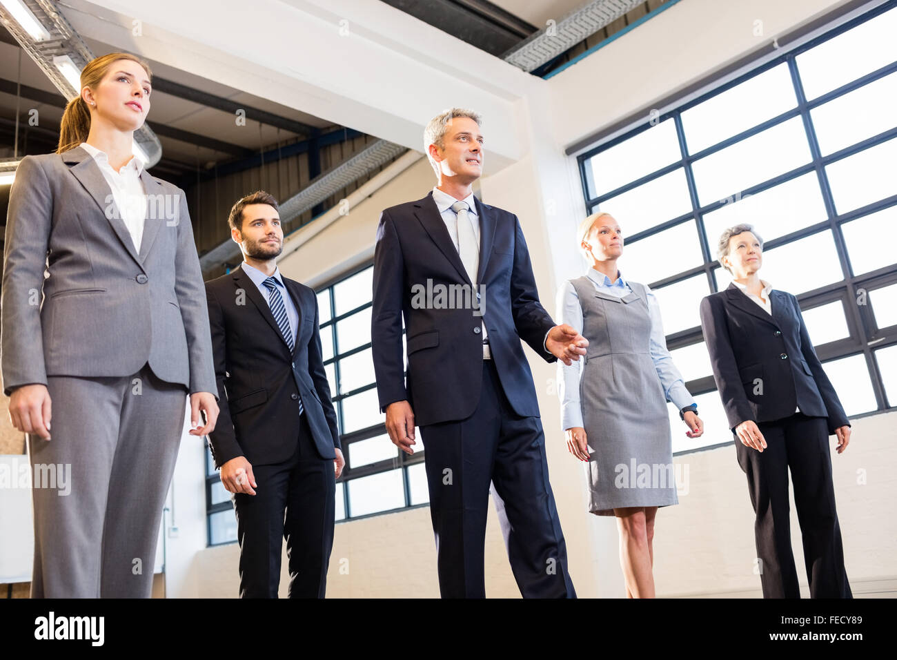 Executives standing in a row hi-res stock photography and images - Alamy