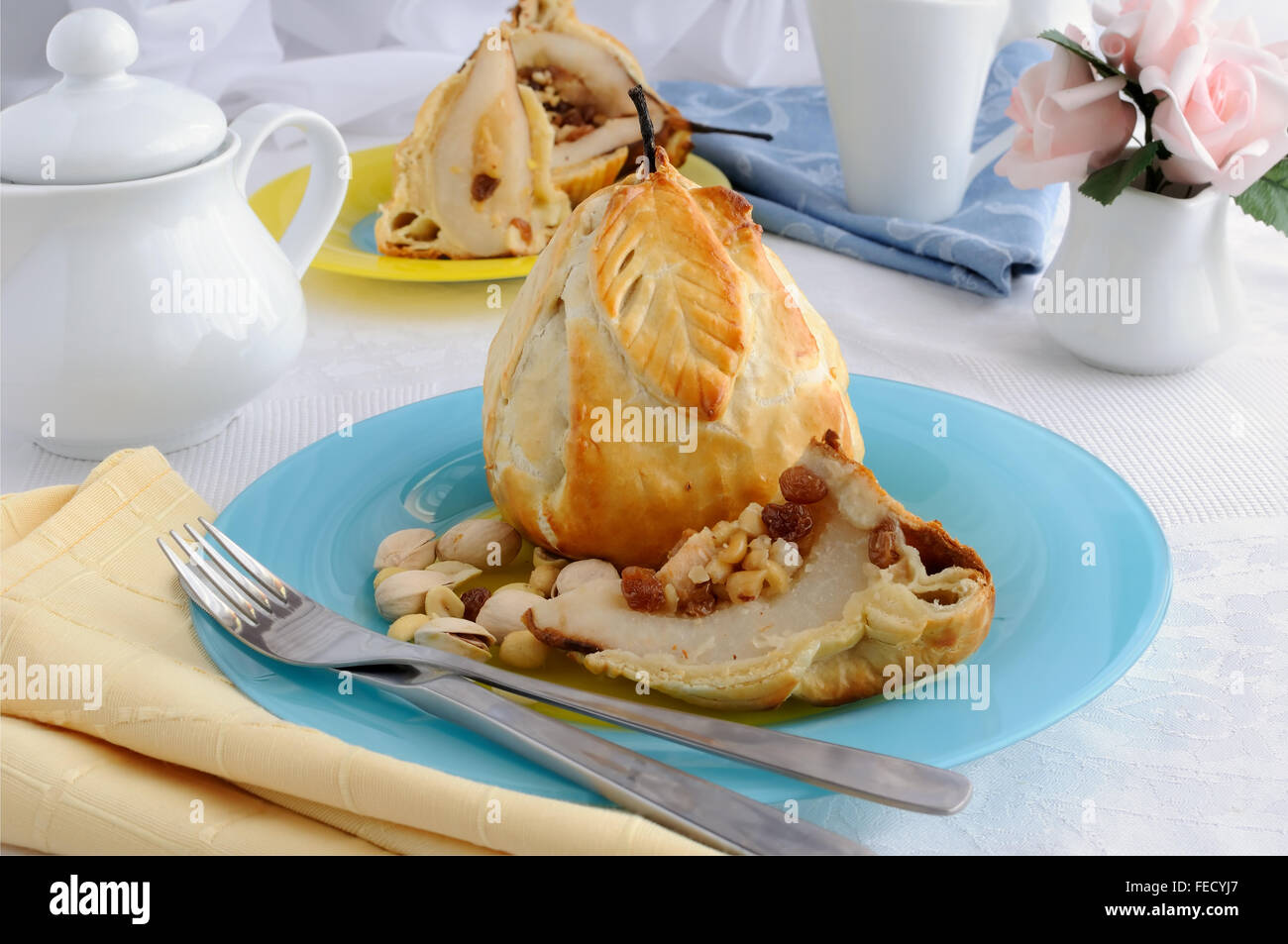 Baked pears stuffed with a mixture of nuts and raisins in the dough Stock Photo