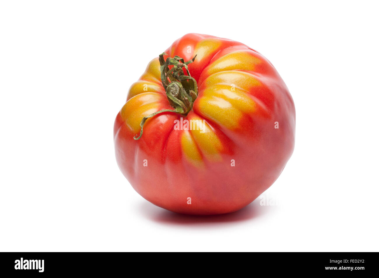 Fresh single Coeur de Boeuf tomato on white background Stock Photo - Alamy