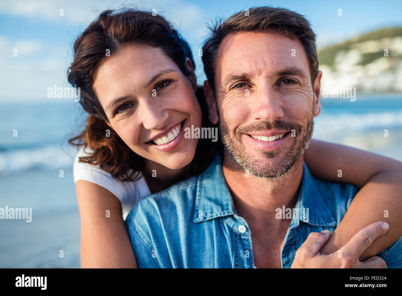Cute couple cuddling with arms around Stock Photo Alamy