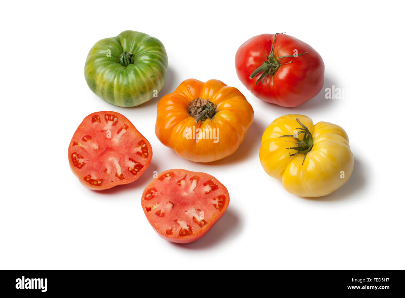 Diversity of Beefsteak Tomatoes on white background Stock Photo
