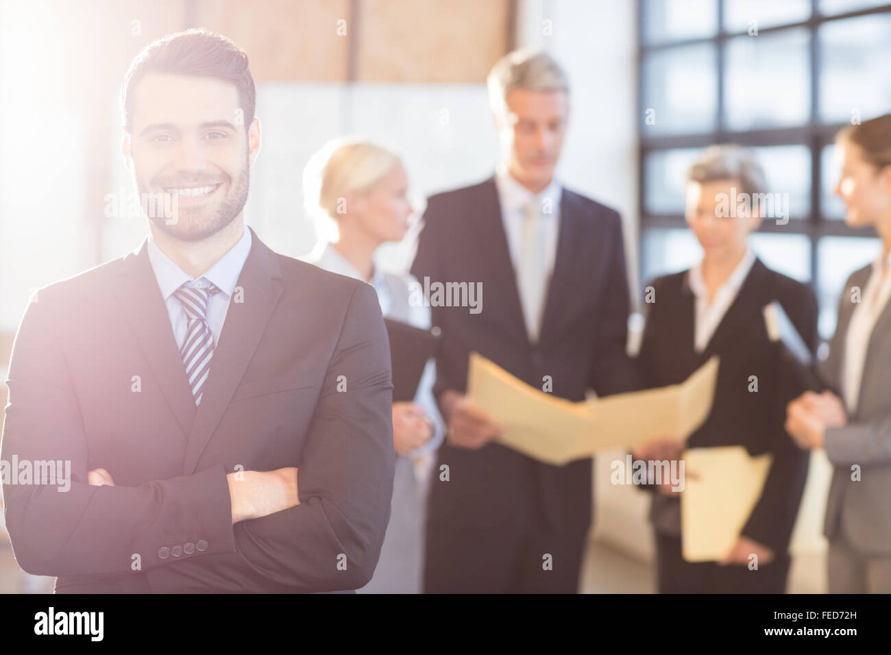 Businessman smiling at the camera Stock Photo - Alamy