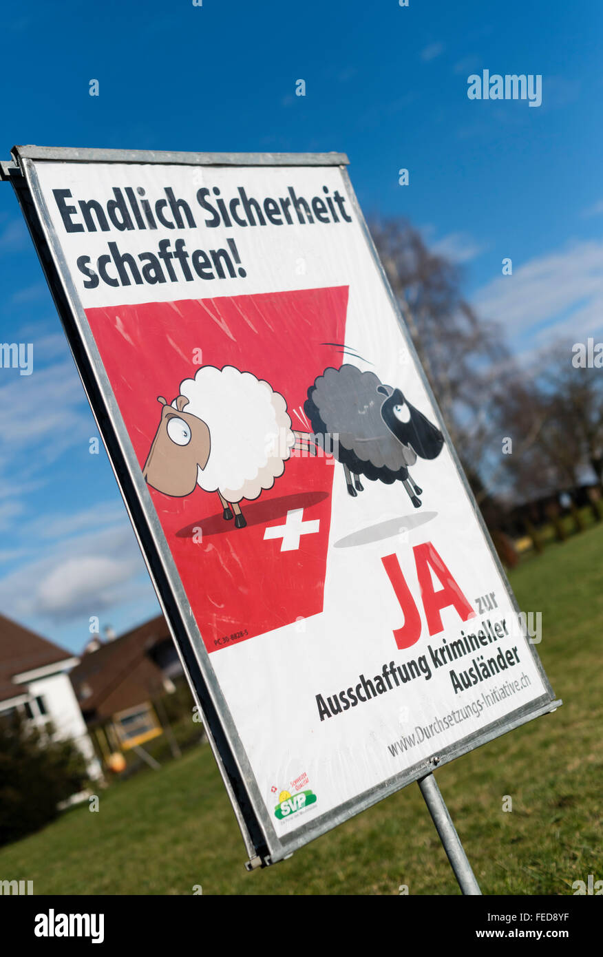 A referendum campaign poster 'For the effective expulsion of foreign criminals' on a field in rural Switzerland. Stock Photo