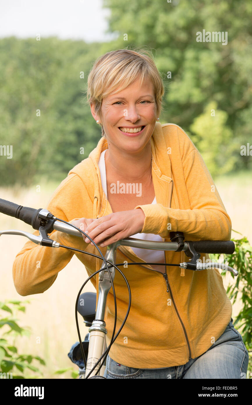 Woman with bicycle, portrait Stock Photo