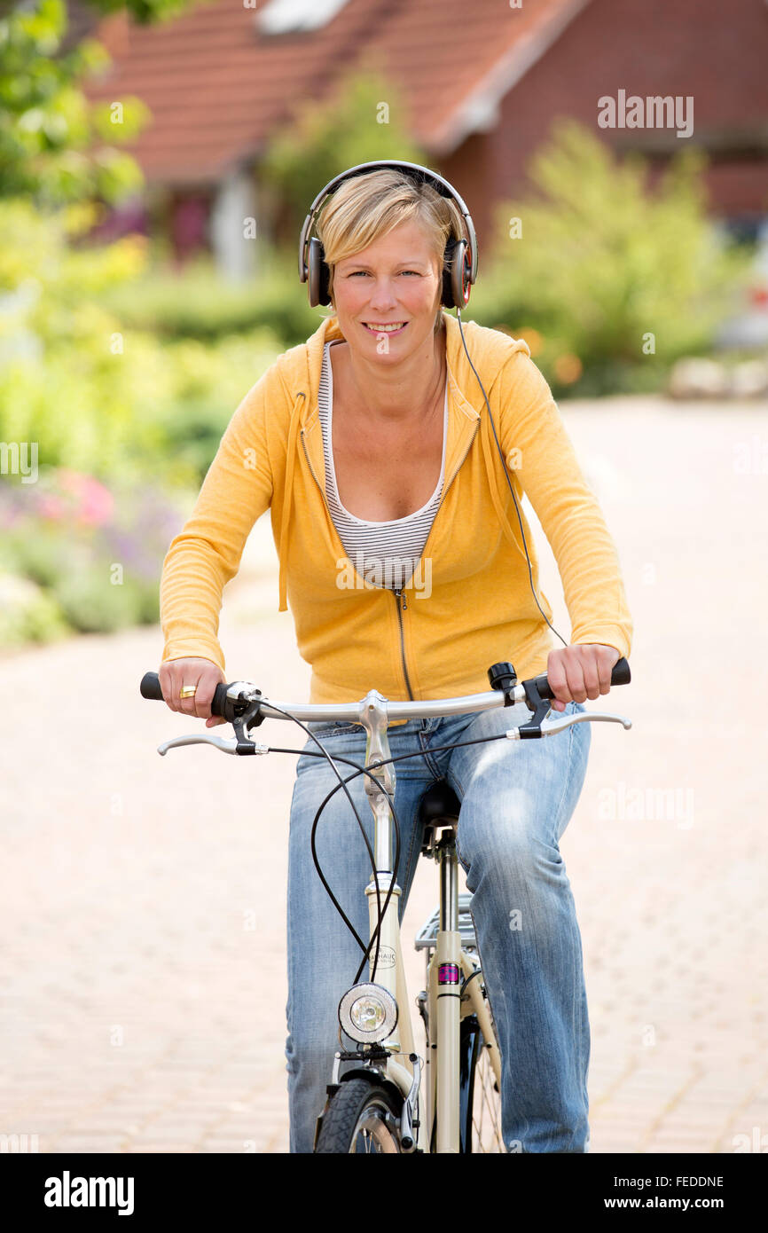 Woman riding bicycle headset hires stock photography and images Alamy