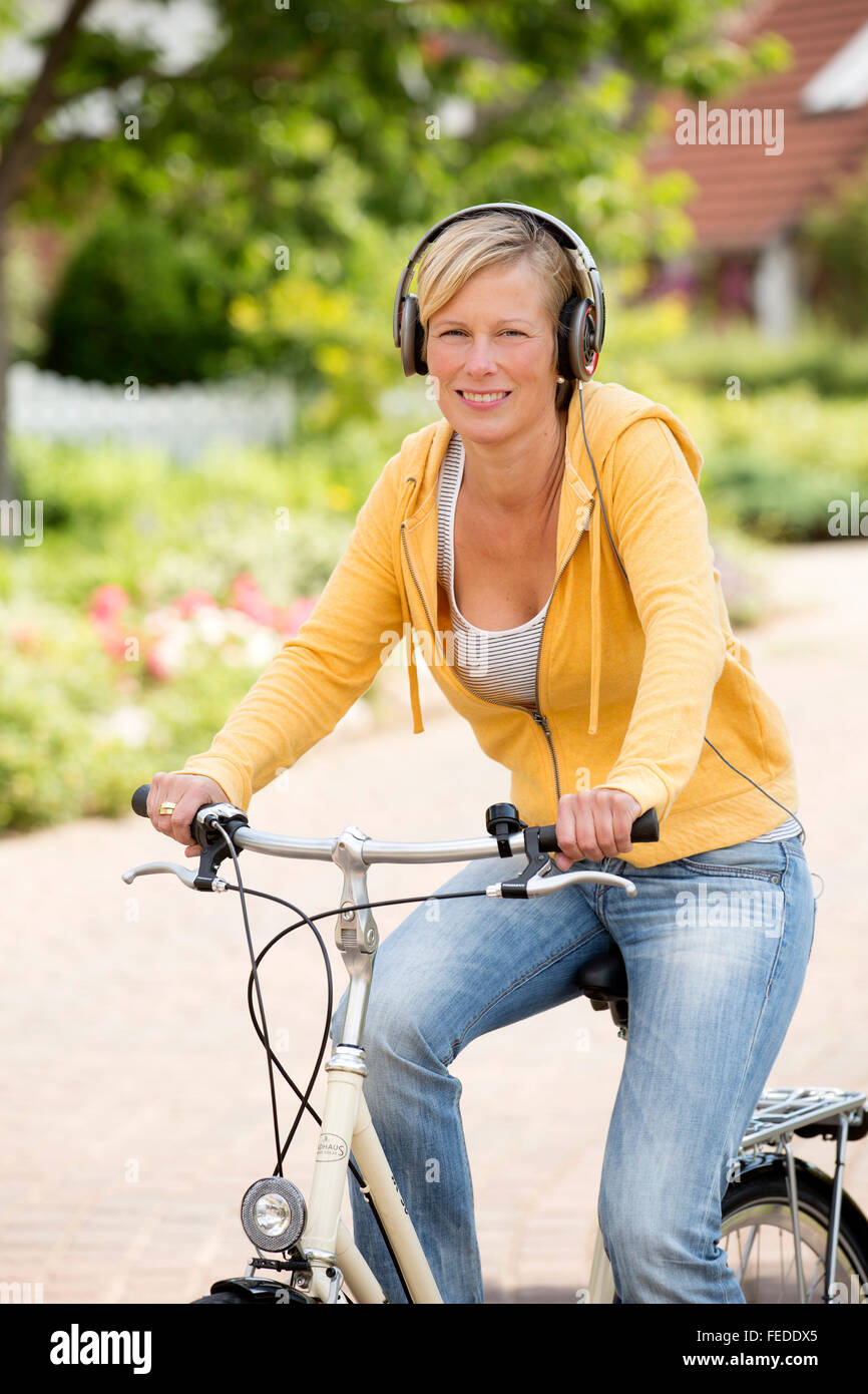 Woman riding bicycle headset hires stock photography and images Alamy