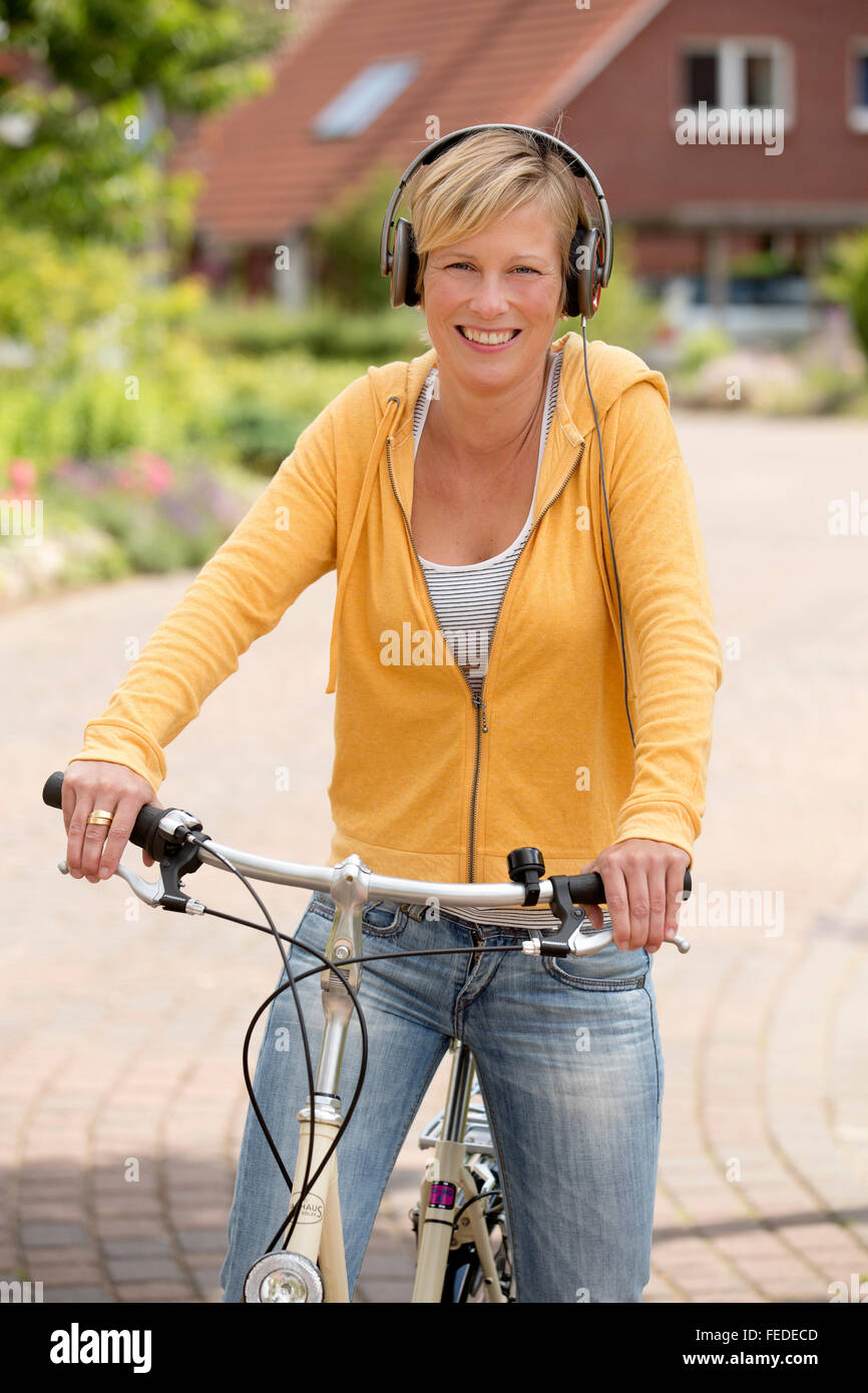 Woman riding bicycle headset hires stock photography and images Alamy