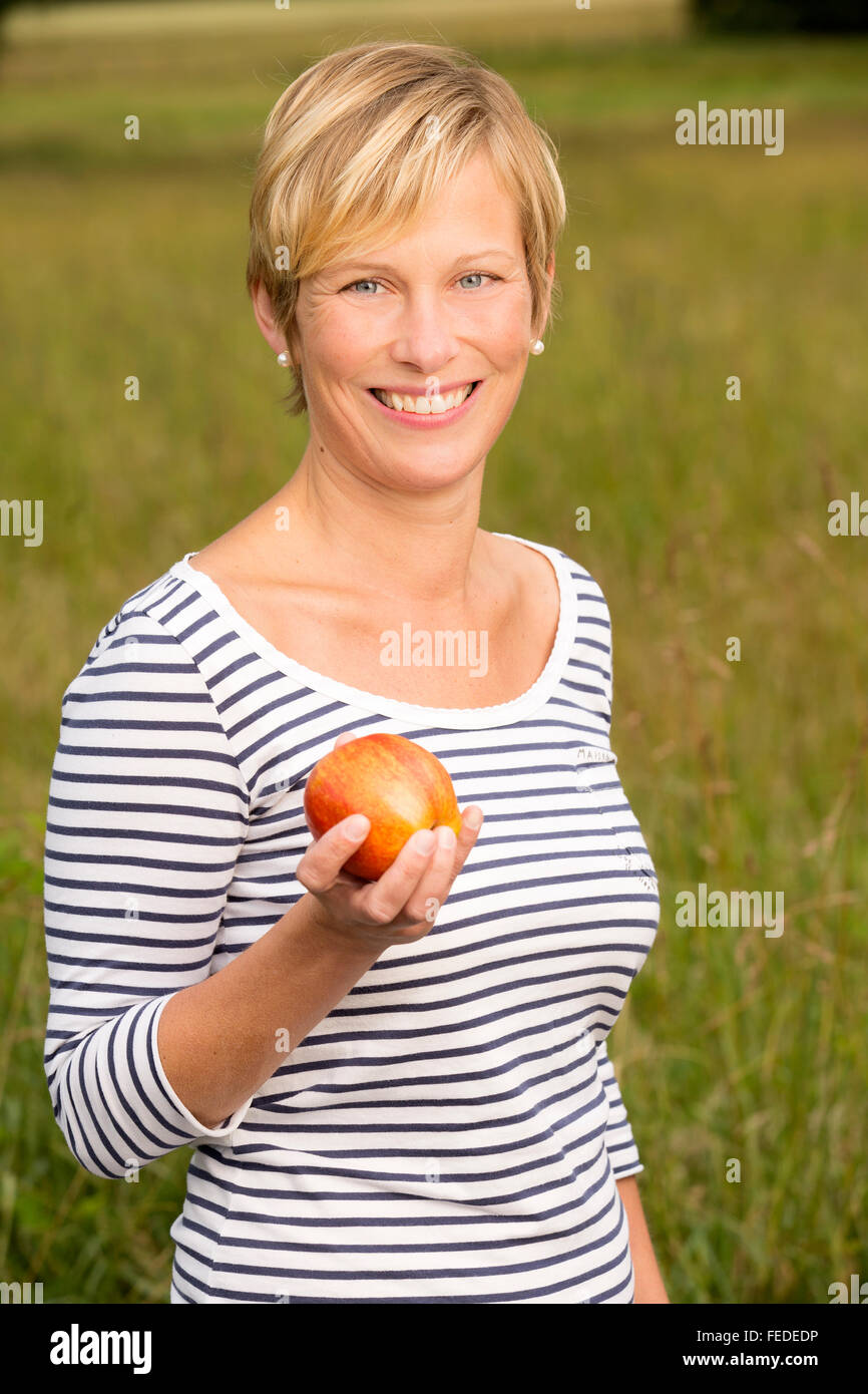 Woman with an apple Stock Photo