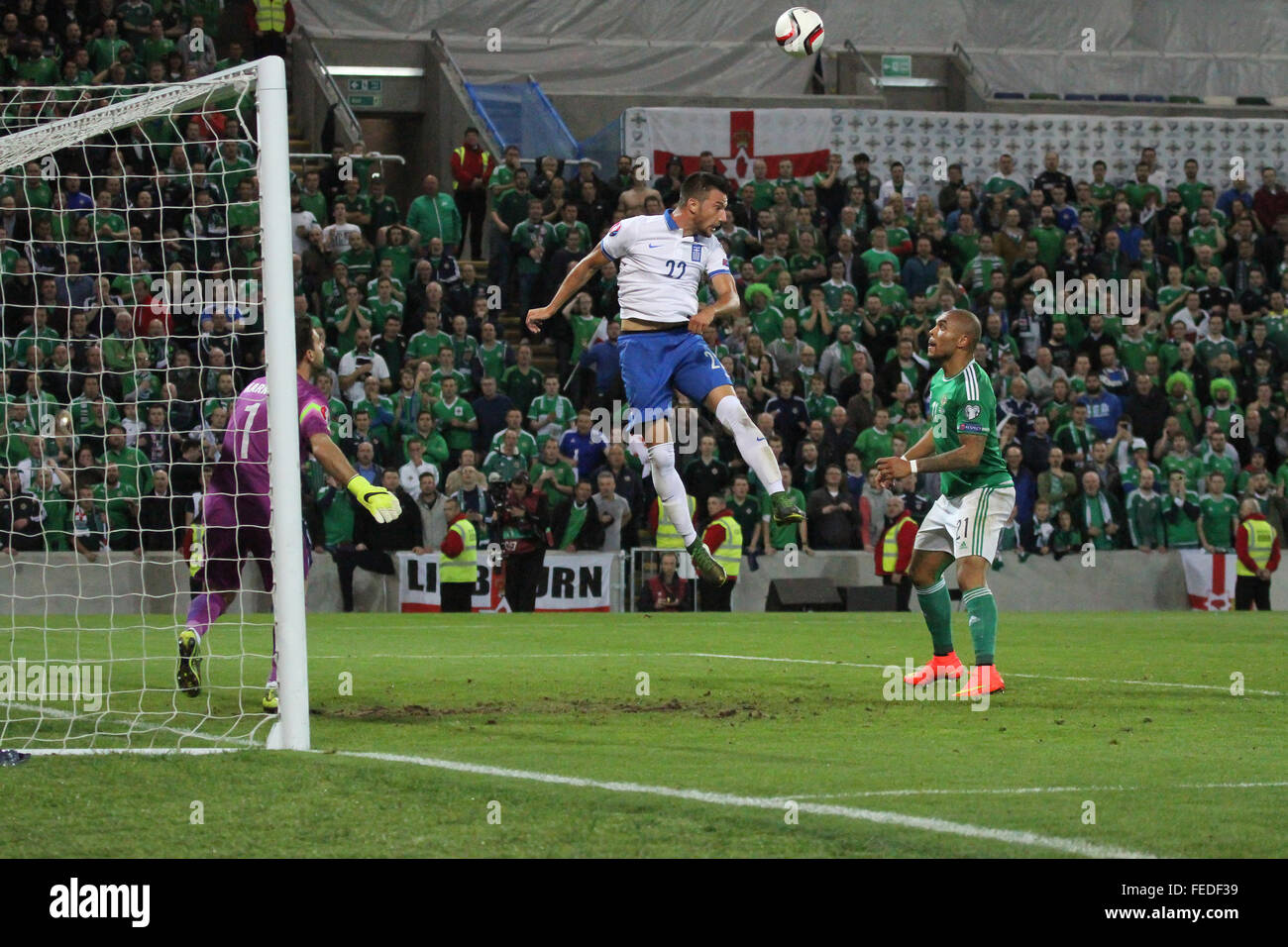 08 Oct 2015 - Euro 2016 Qualifier - Group F - Northern Ireland 3 Greece 1. Greece's Andreas Samaris (22) heads clear. Stock Photo
