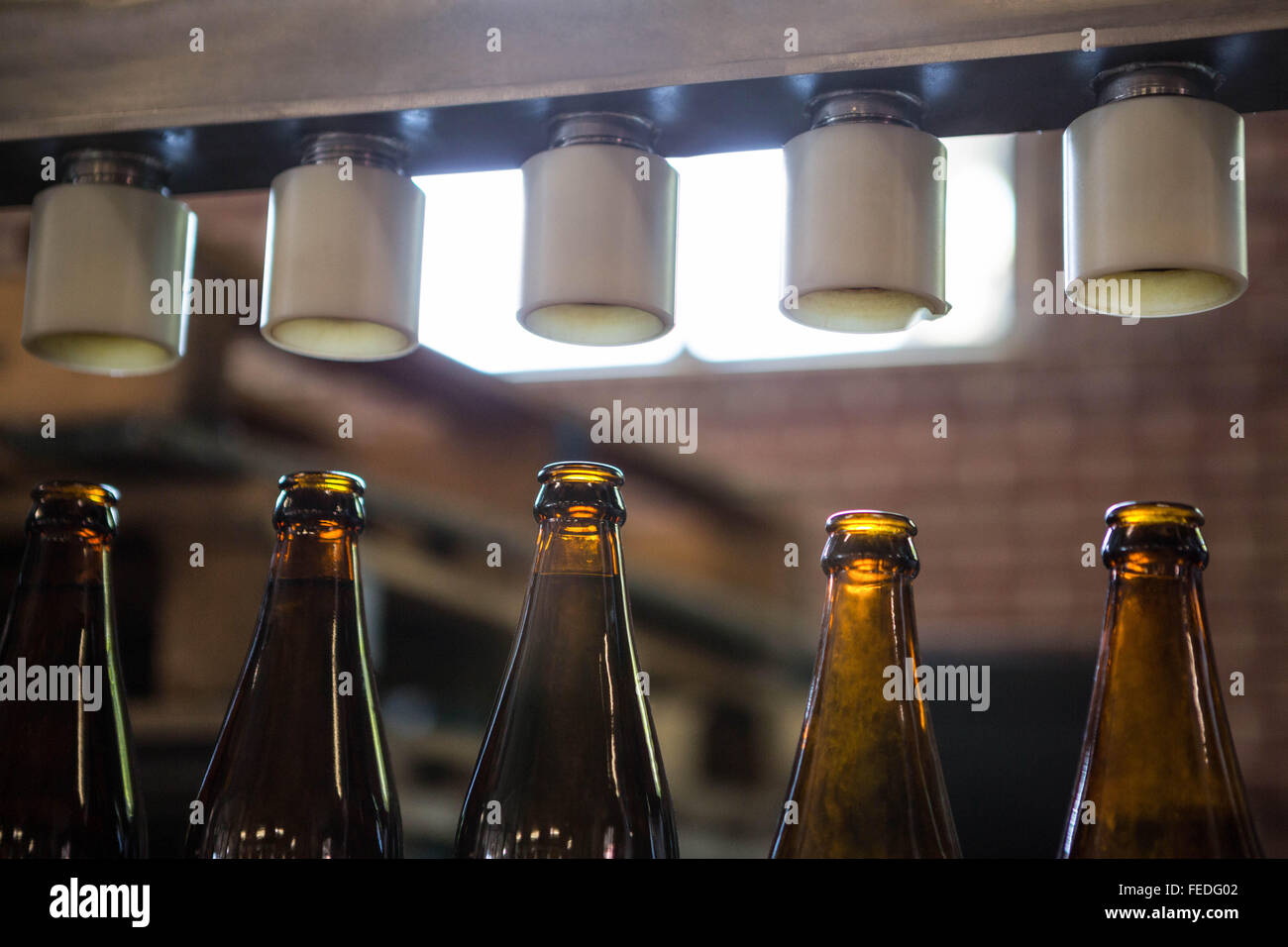 Bottling machine preparing beer bottles hires stock photography and